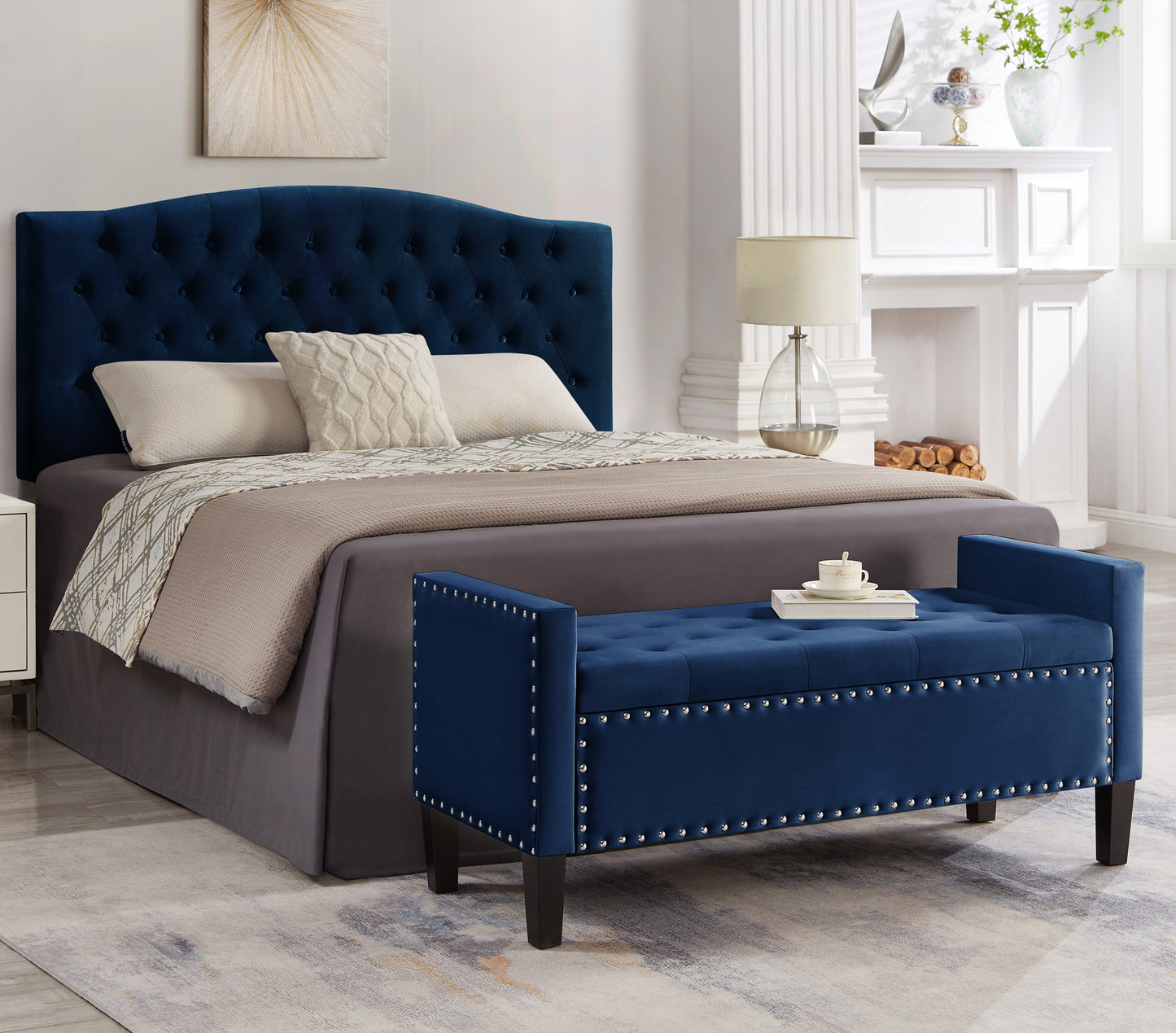 Deep blue velvet storage bench with button tufting and silver nailhead trim
