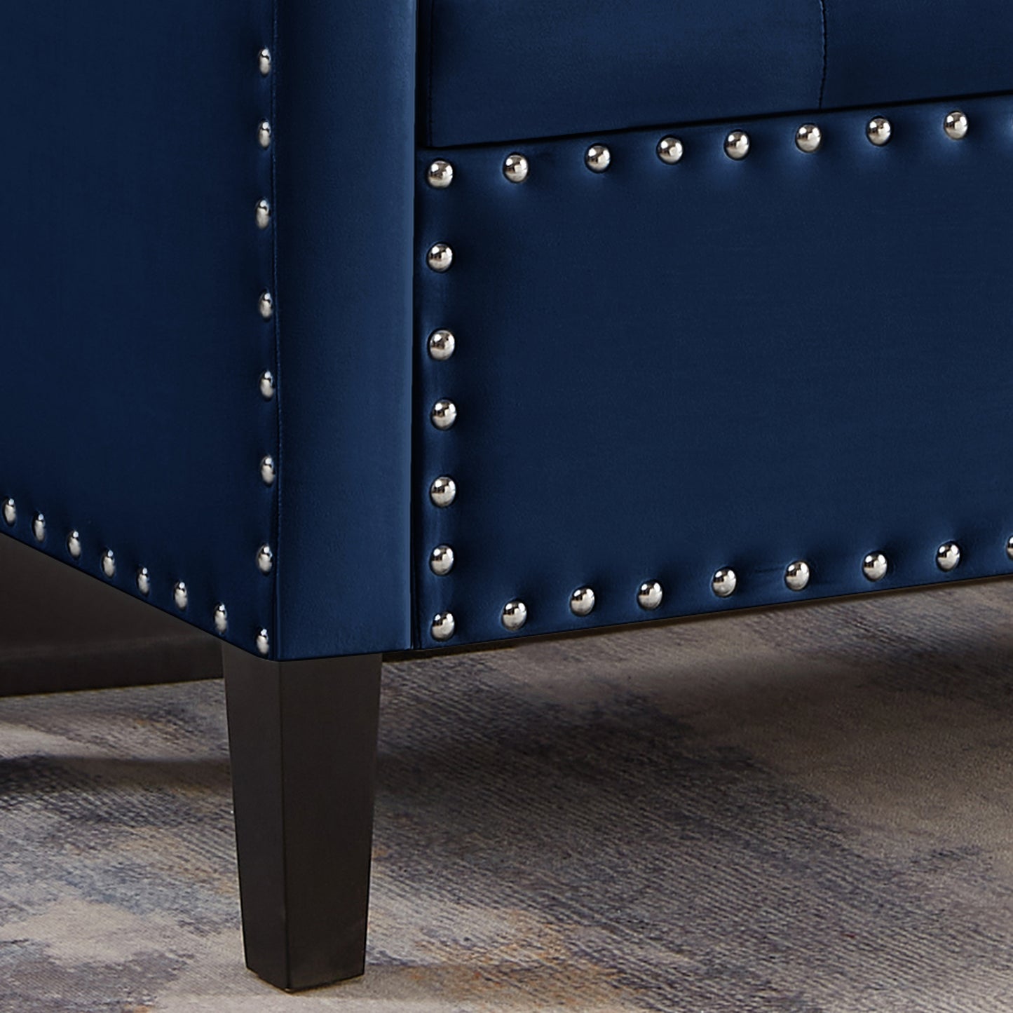 Navy velvet sofa detail with silver nailhead trim