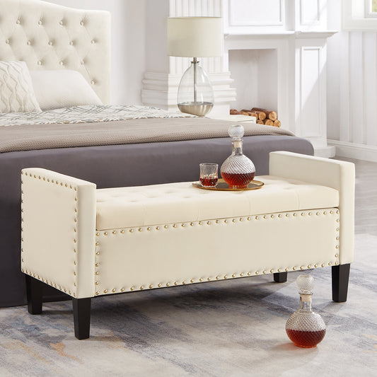 Cream velvet upholstered storage bench with gold nailhead trim and tufted seat
