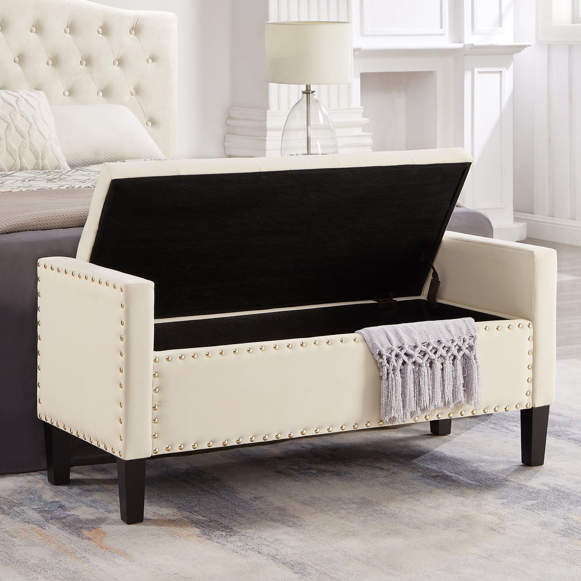 Cream velvet storage bench with gold nailhead trim