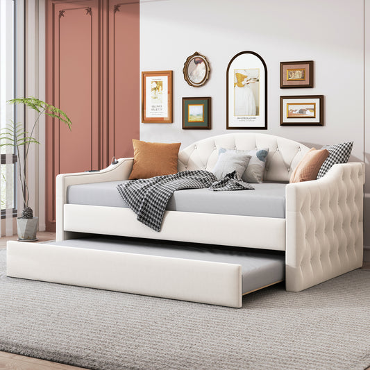Cream upholstered daybed with tufted back and pullout trundle
