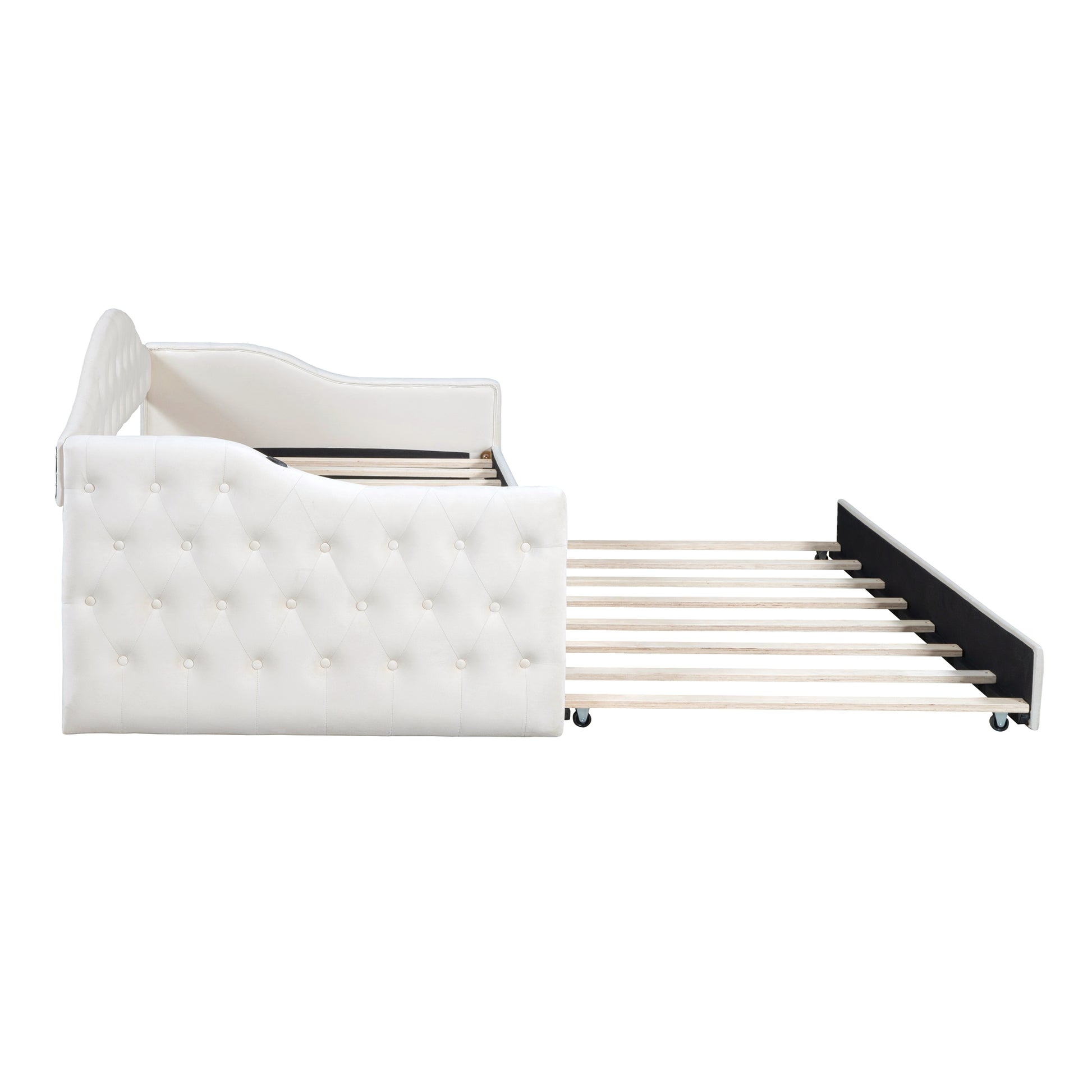 White upholstered daybed with tufted detailing and a pullout trundle