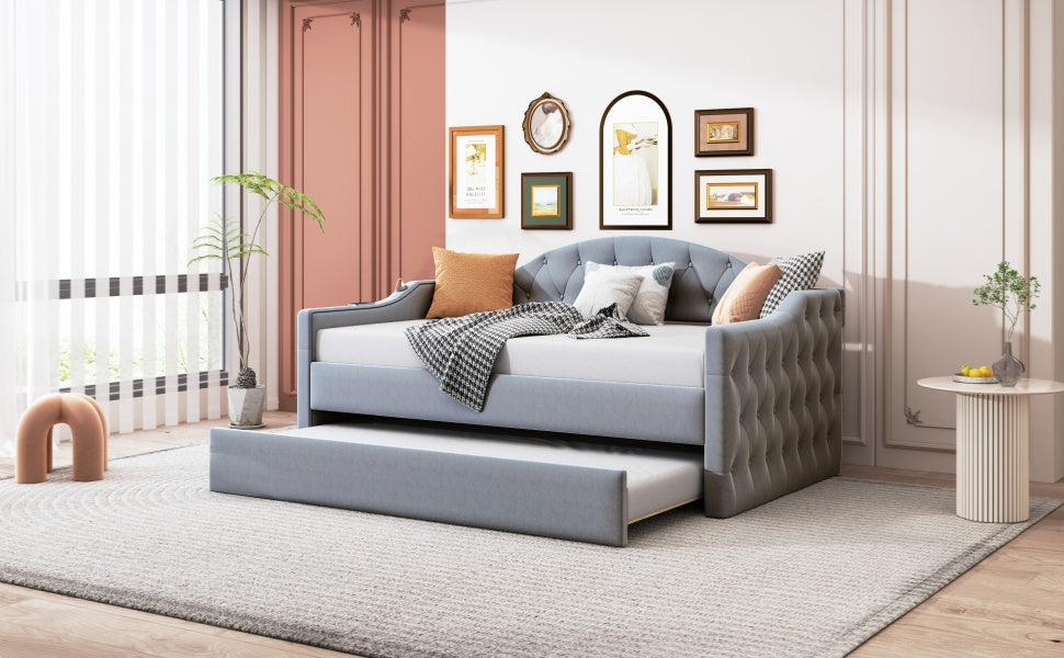 Blue velvet daybed with tufted accents and a pullout trundle
