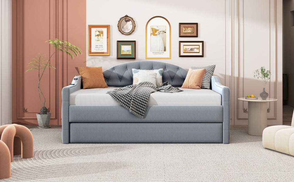 Light blue upholstered daybed with tufted headboard and pullout trundle perfect for guest rooms