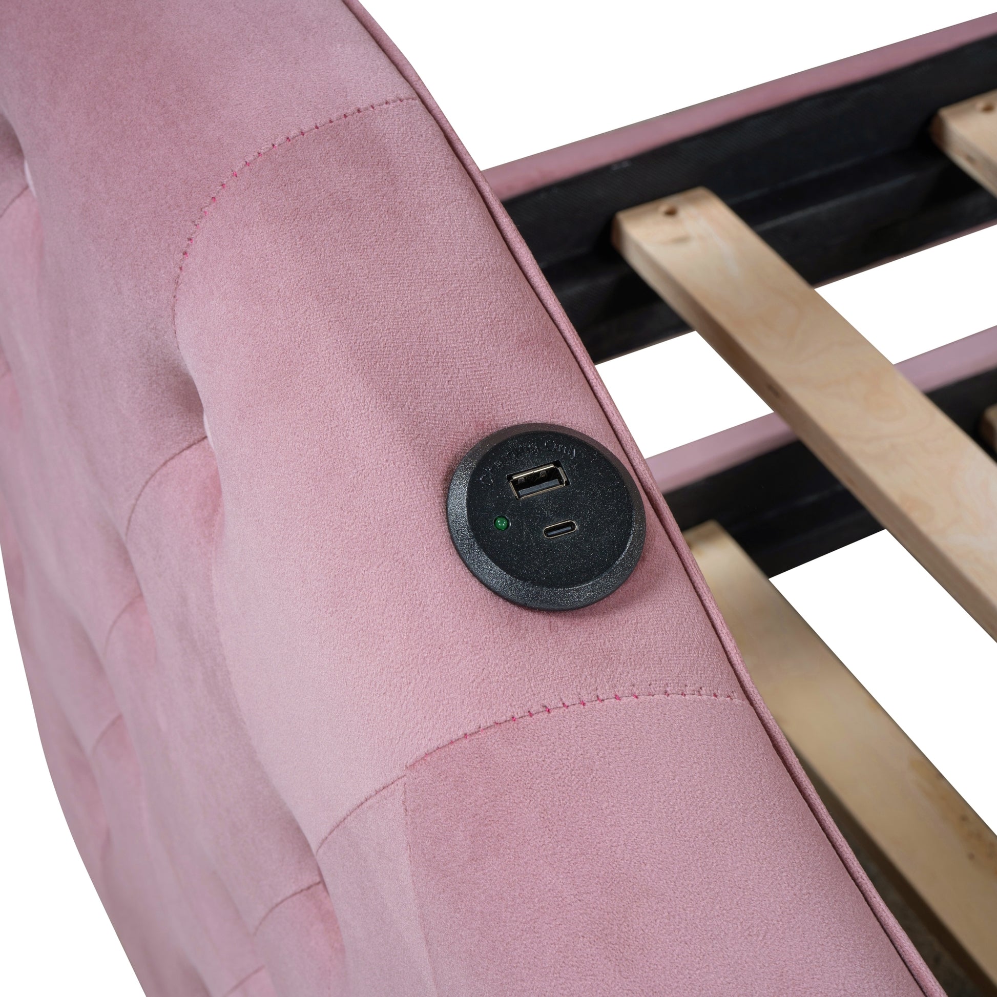 Pink upholstered bed frame with integrated USB charging port