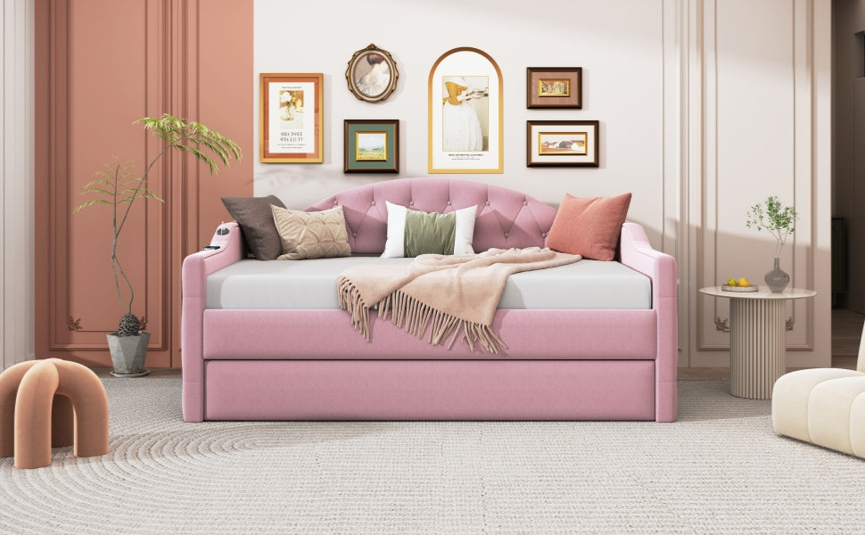 Pink velvet daybed with pullout trundle button tufting and matching pillows for a cozy bedroom