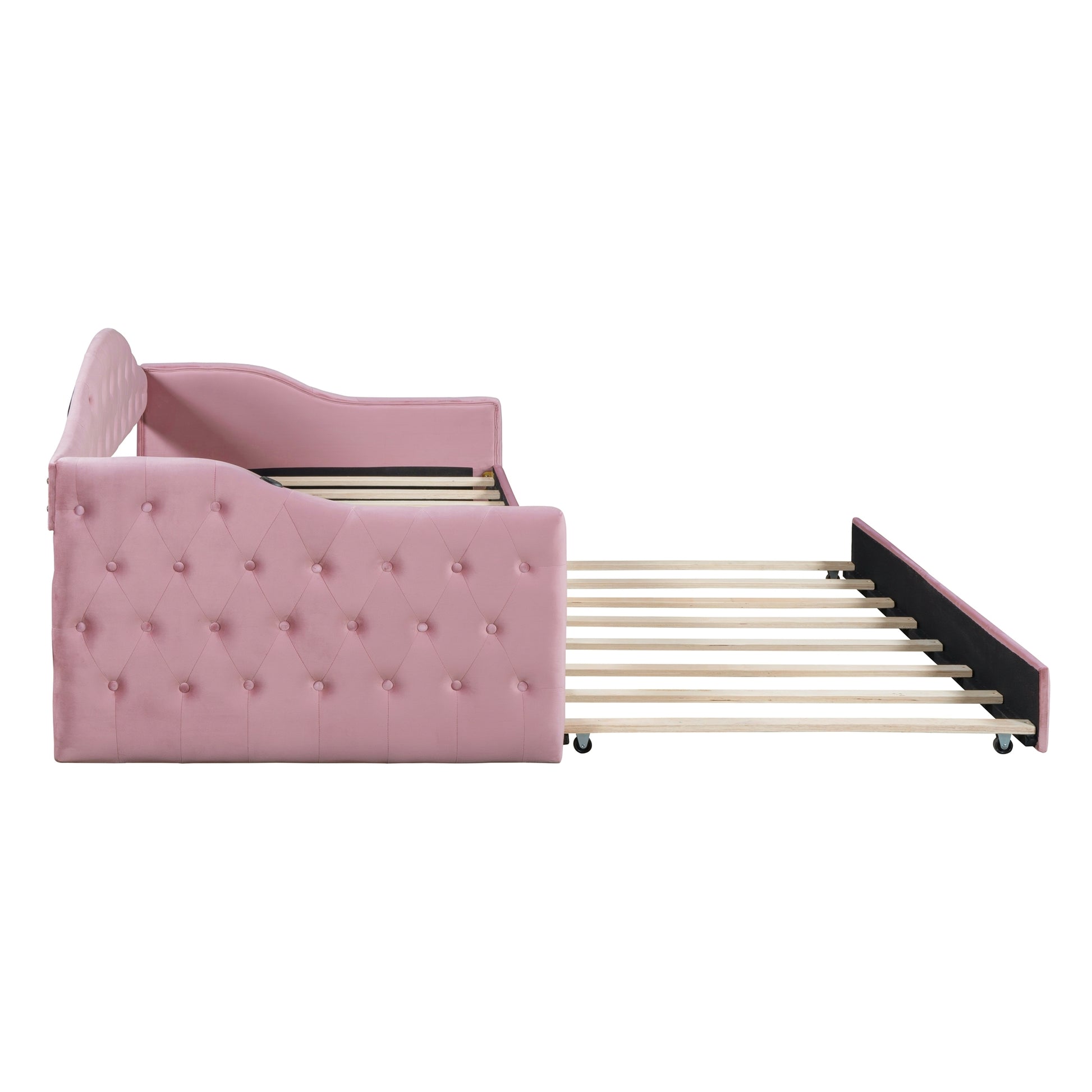 Pink velvet tufted daybed with pullout trundle bed frame shown from the side