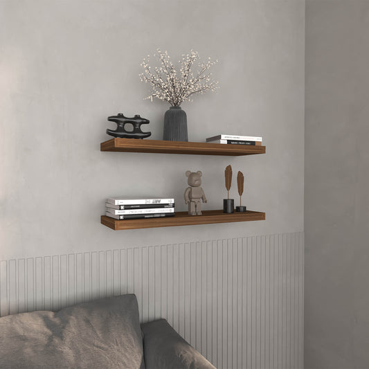 Floating walnut shelf with black abstract sculpture and vase of white flowers