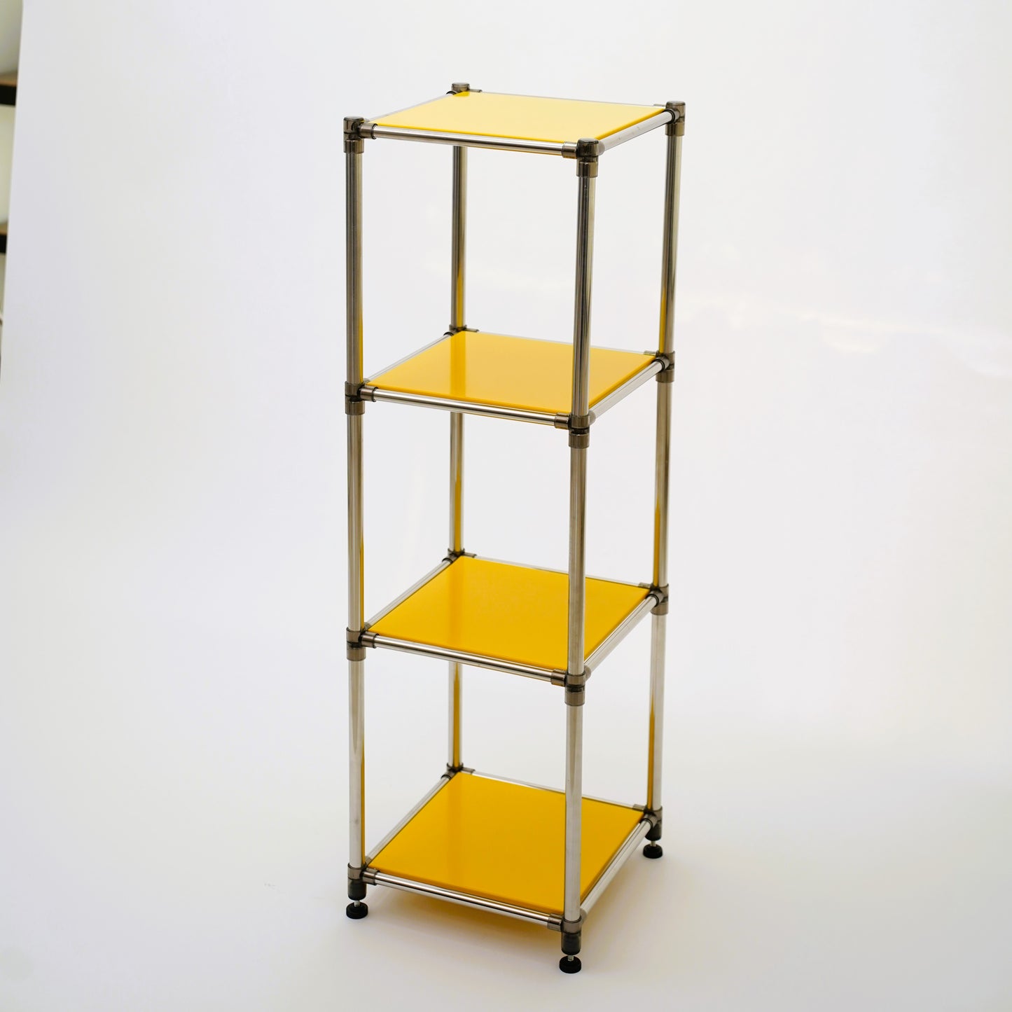 Yellow acrylic fourtier shelving unit with chrome frame
