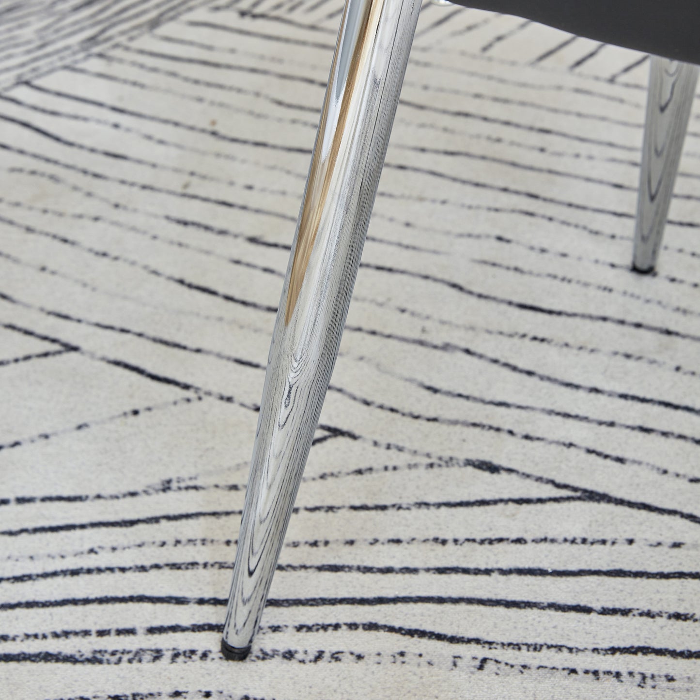 Textured wood grain chair leg with chrome accents