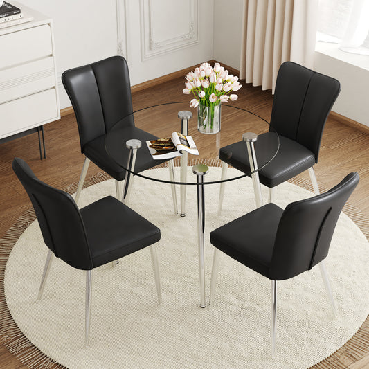Black leather dining chairs with chrome legs around a clear glass round table