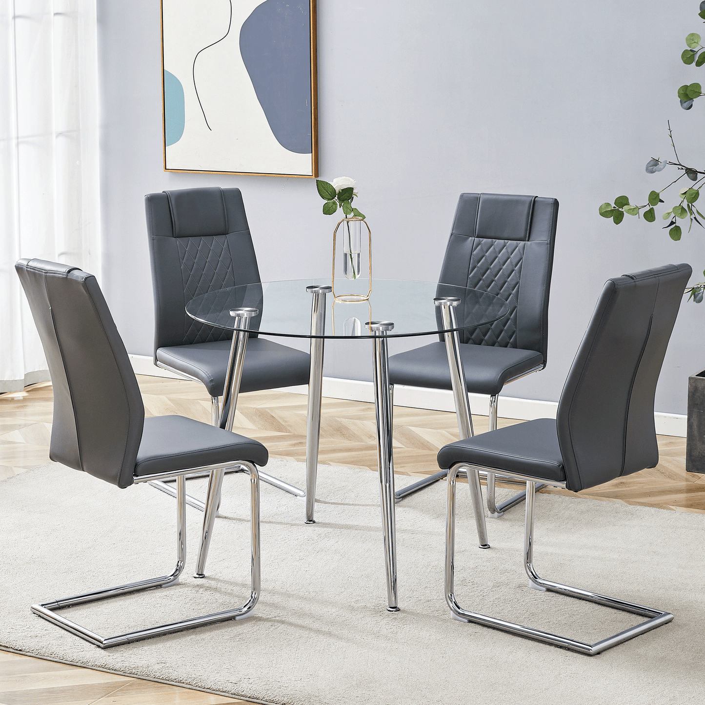 Modern glass top dining table with four grey faux leather chairs