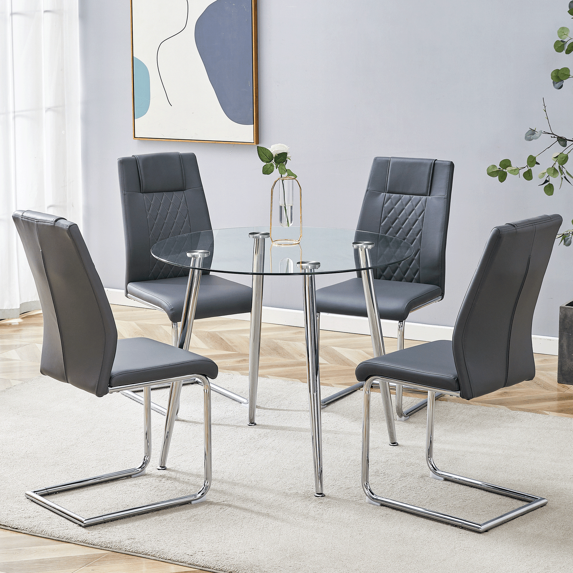 Modern glass top dining table with four grey faux leather chairs