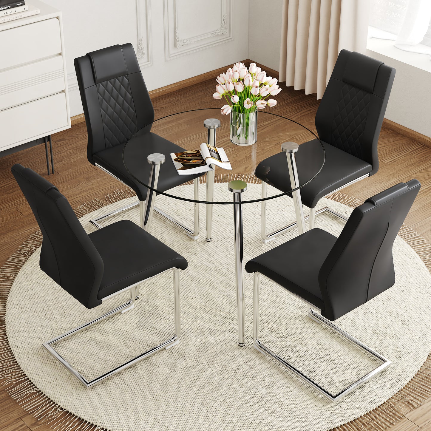 Black faux leather dining chairs with diamond stitching around a clear glass table