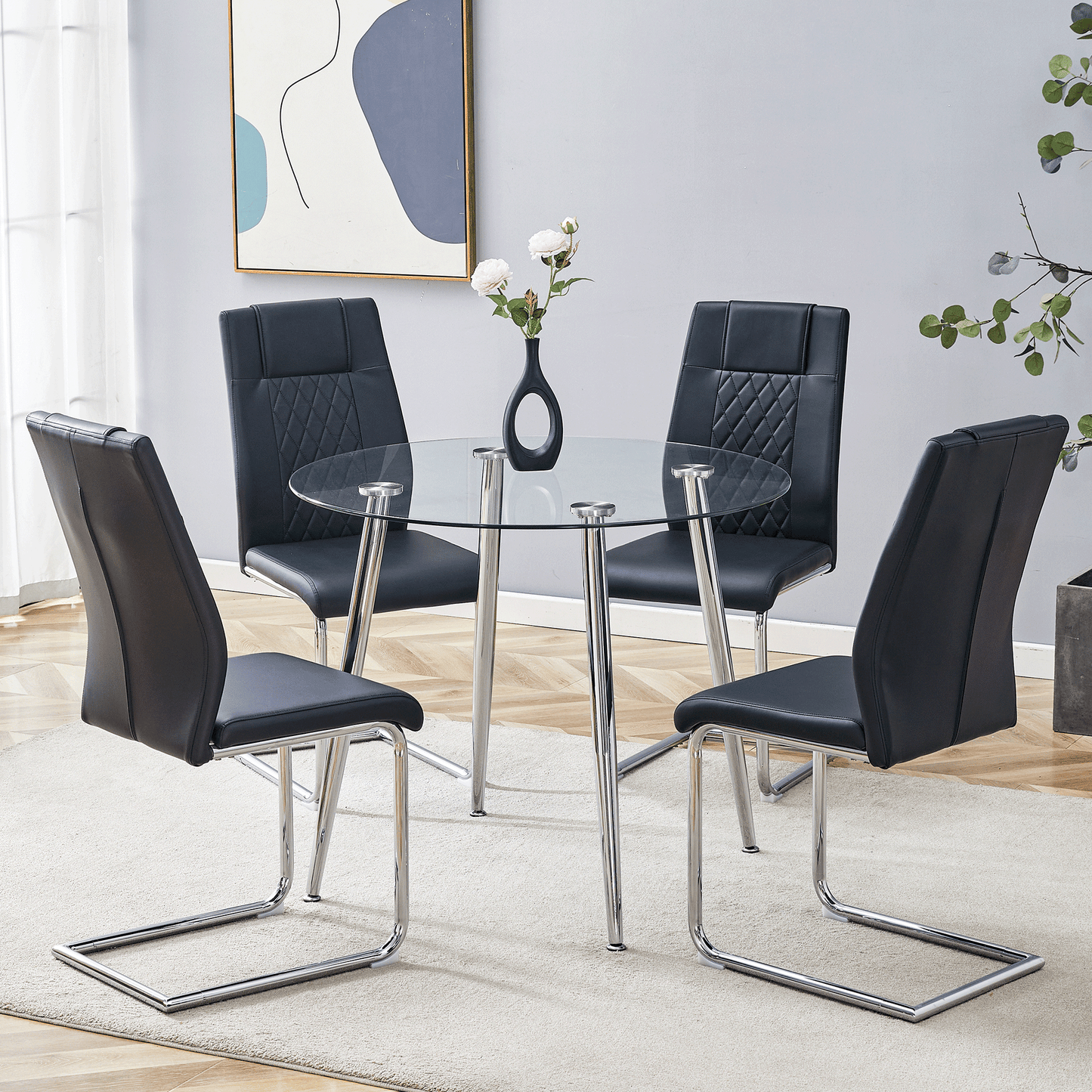 Modern black faux leather dining chairs with chrome sled bases surround a round glass table