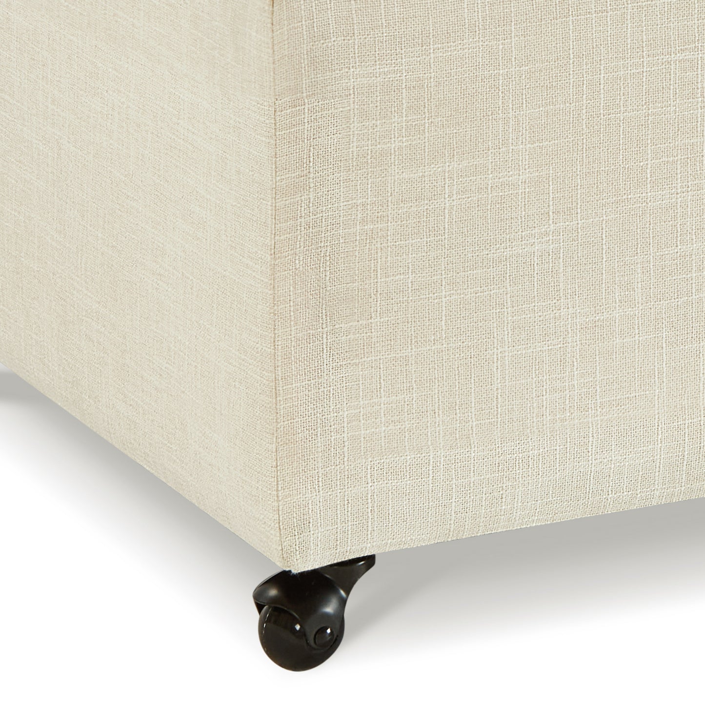 Beige linen upholstered ottoman corner with black caster wheel