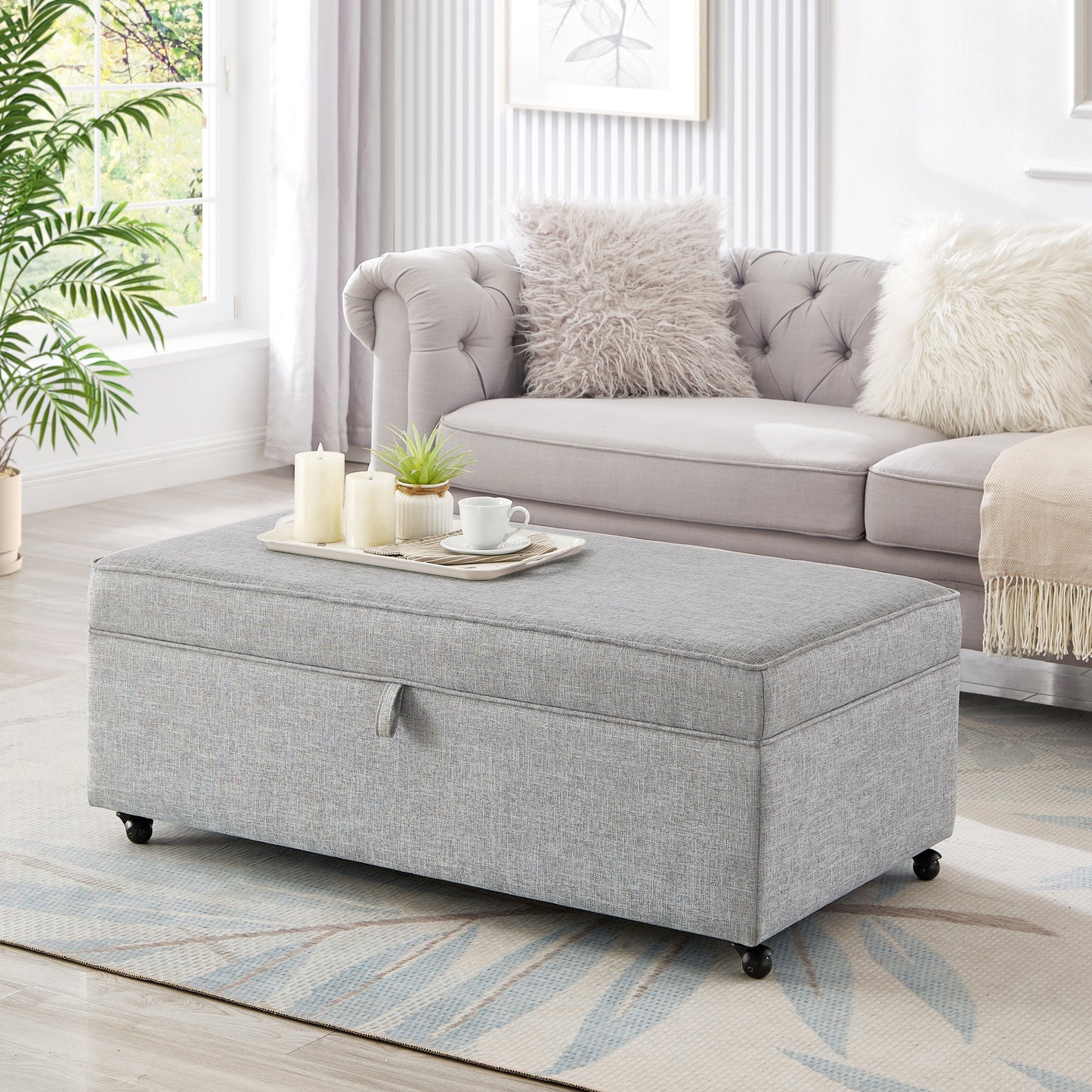 Gray fabric storage ottoman with casters