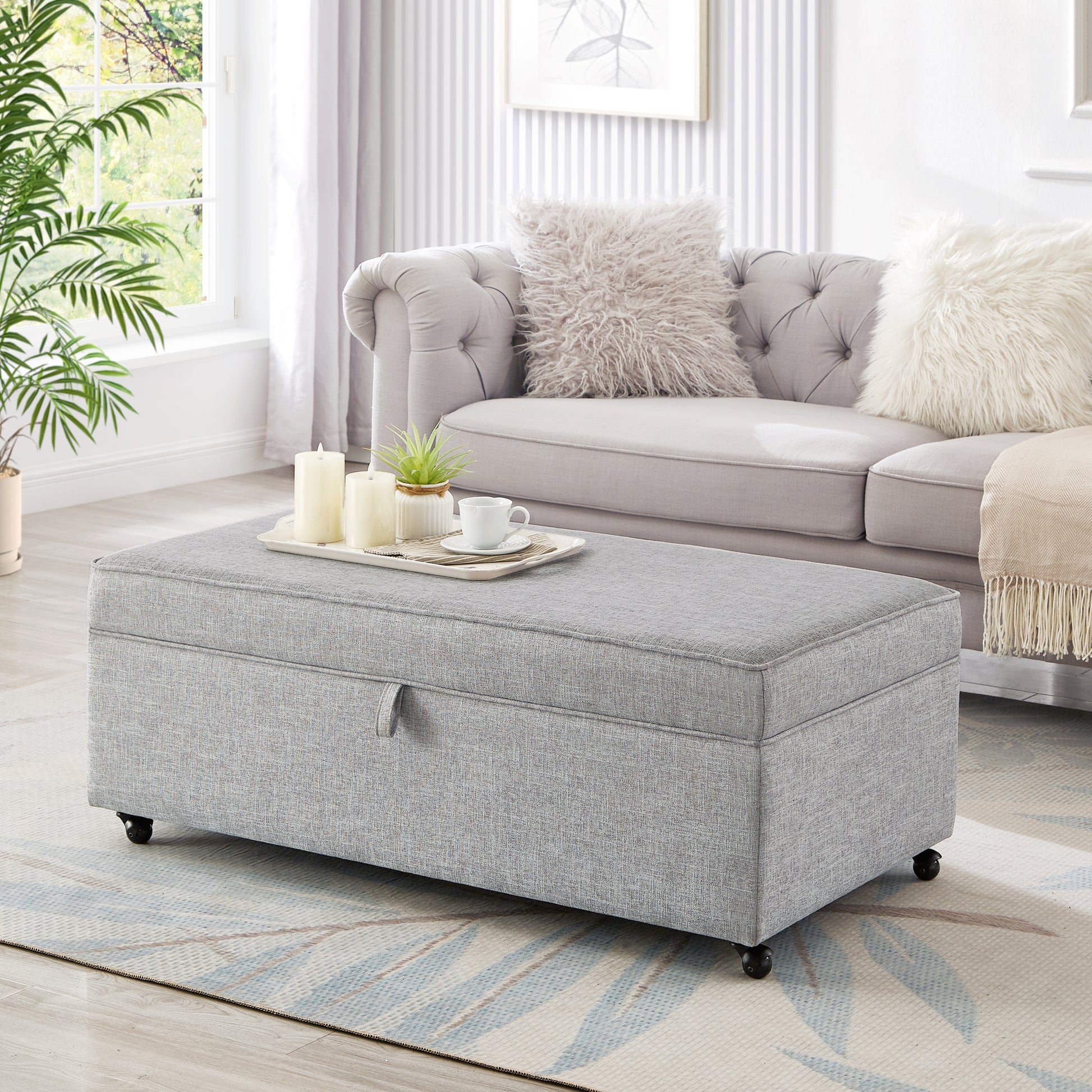 Gray fabric storage ottoman with casters