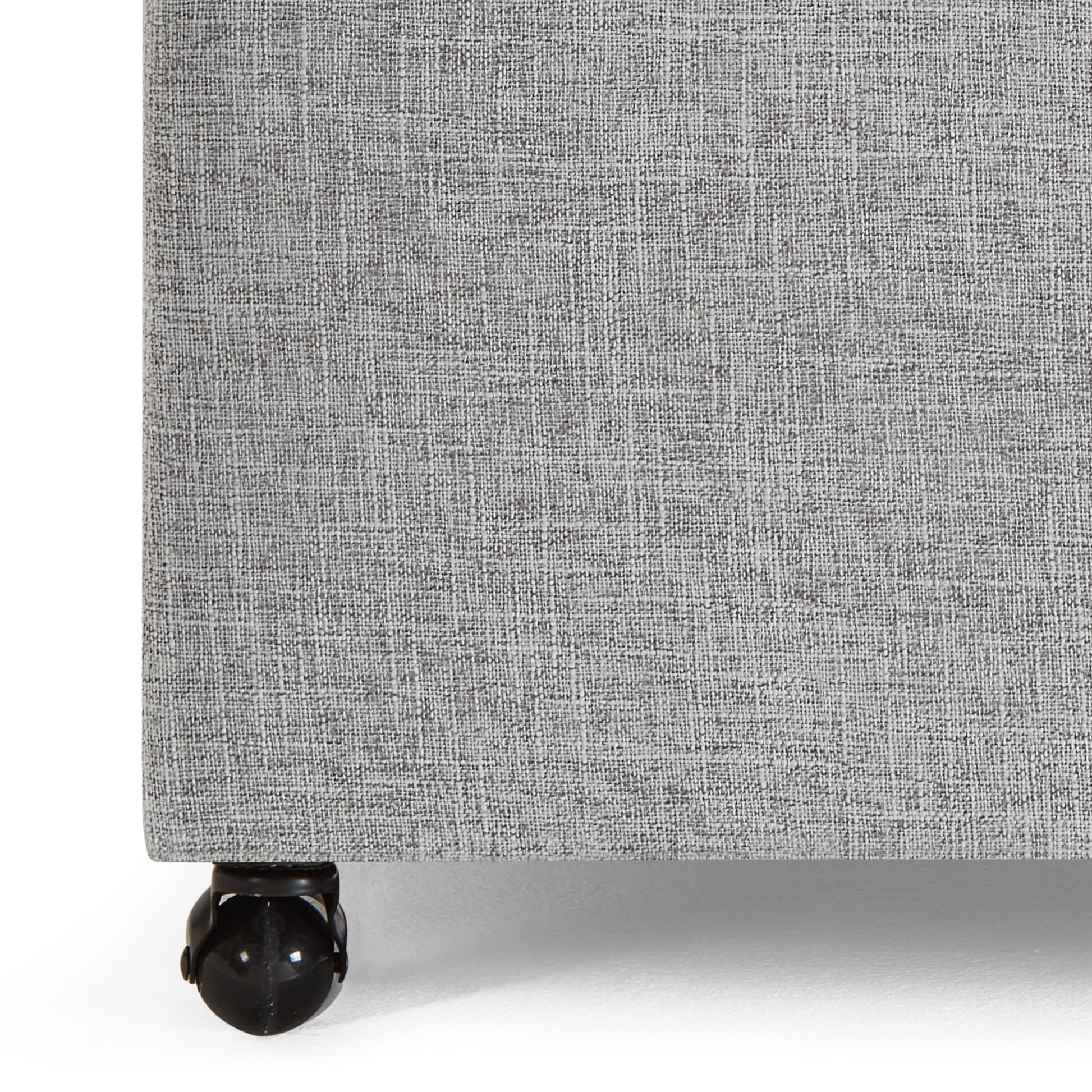 Gray fabric bed frame base with visible casters