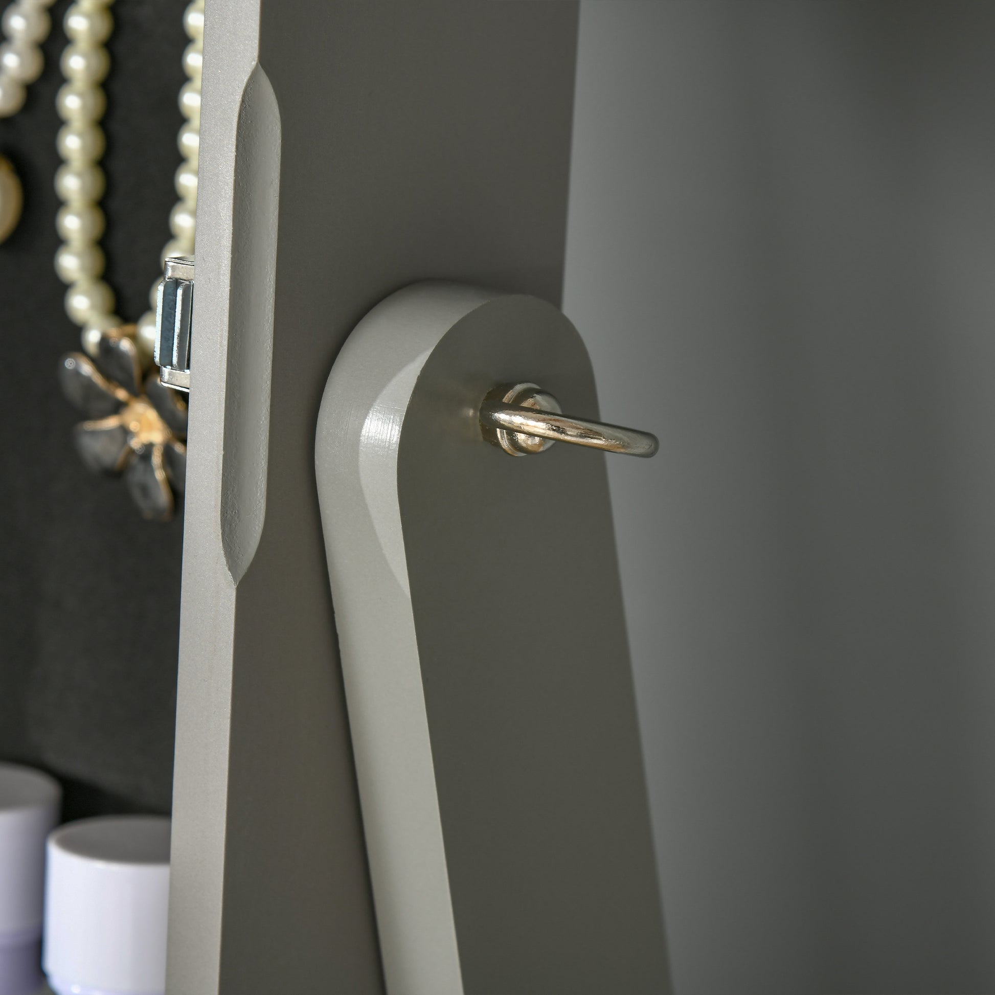 Gray jewelry cabinet door hinge with pearl necklace