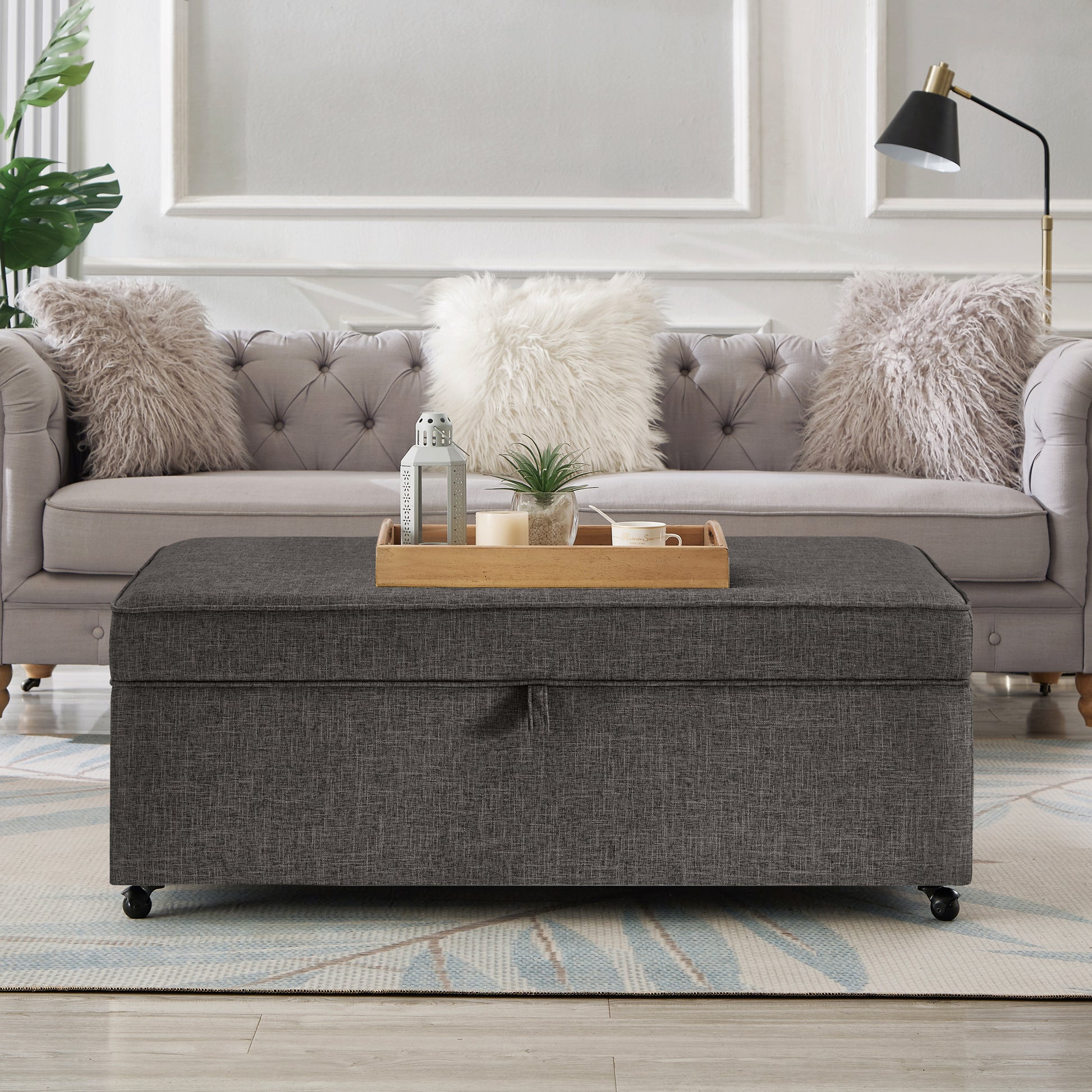Dark grey fabric storage ottoman with rolling casters