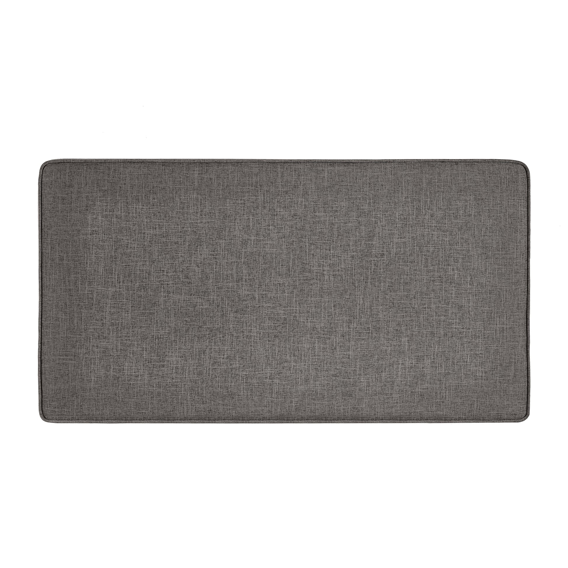 Grey upholstered bench cushion with textured fabric