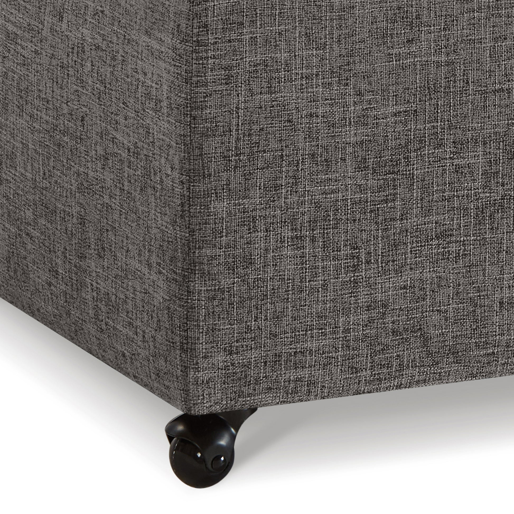Dark grey upholstered storage ottoman with black casters