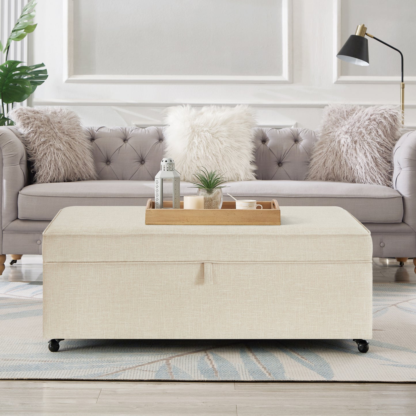 Beige linen storage ottoman with casters and wood tray decor