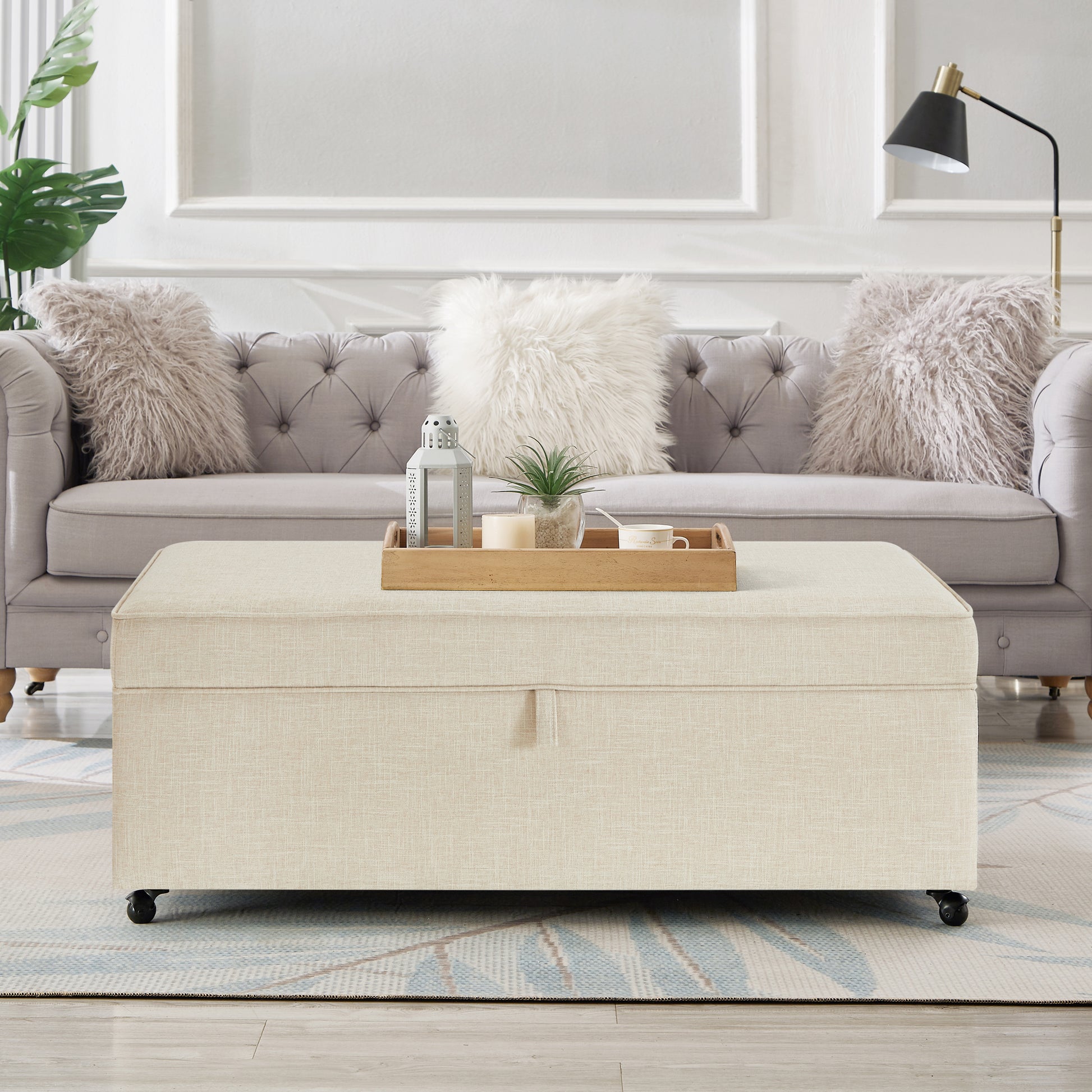 Beige linen storage ottoman with casters and wood tray decor
