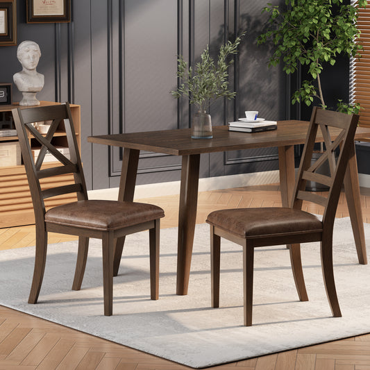 Dark wood dining chairs with crisscross backs and brown faux leather seats