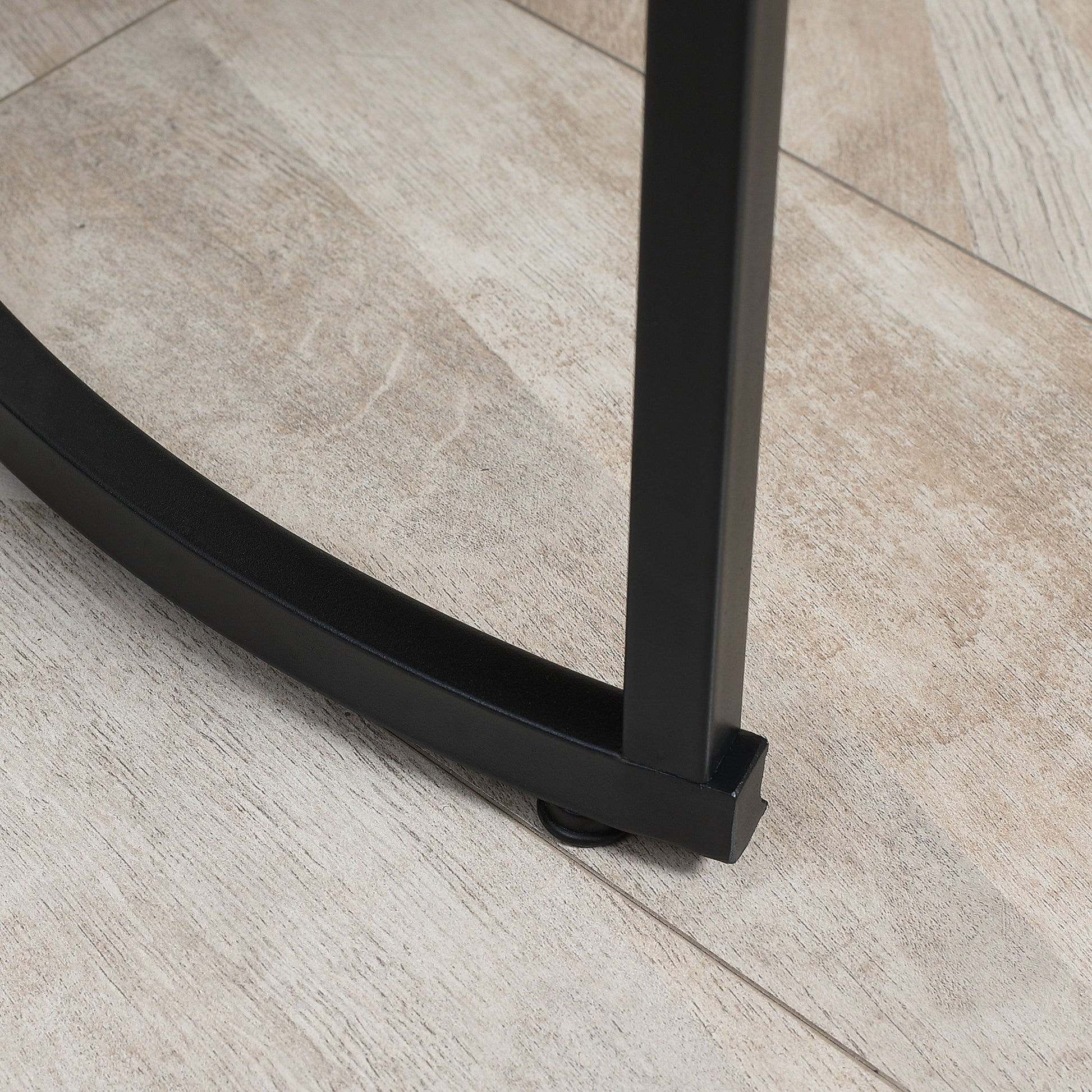 Black metal hairpin legs on light wood grain floor