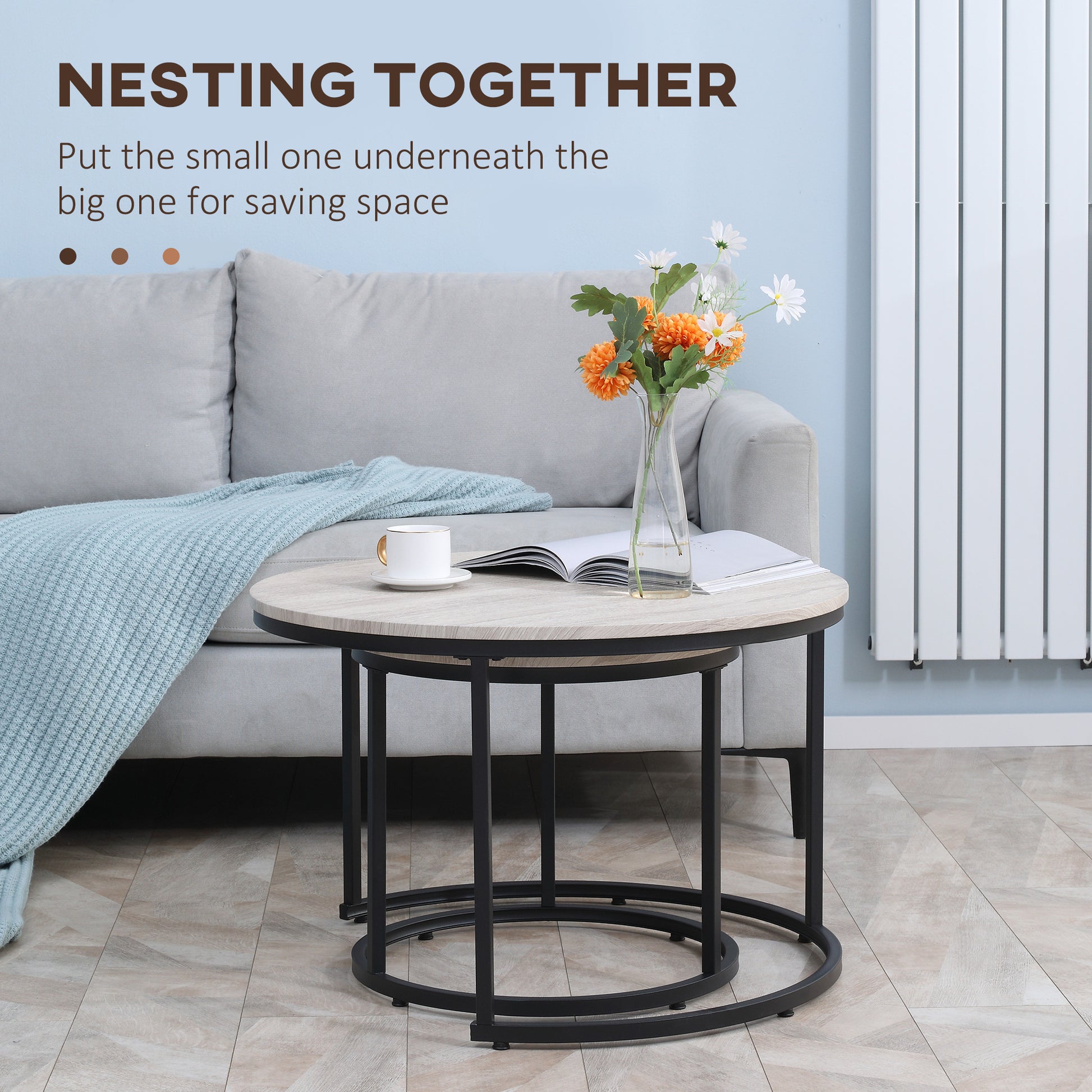 Round nesting coffee tables with light wood top and black metal frame