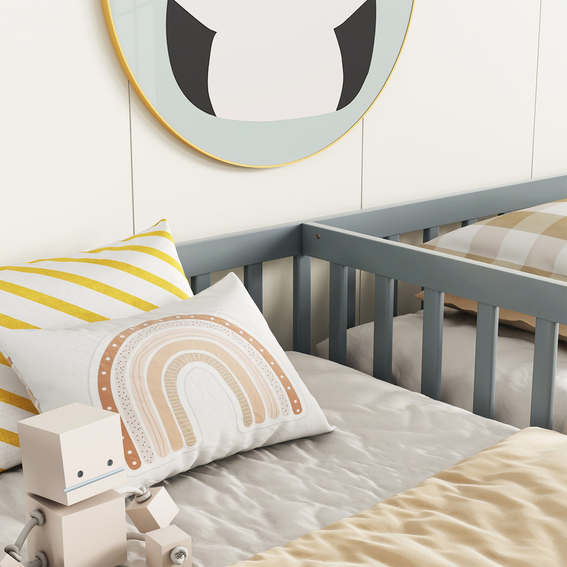 Gray wooden crib with white and yellow striped pillow