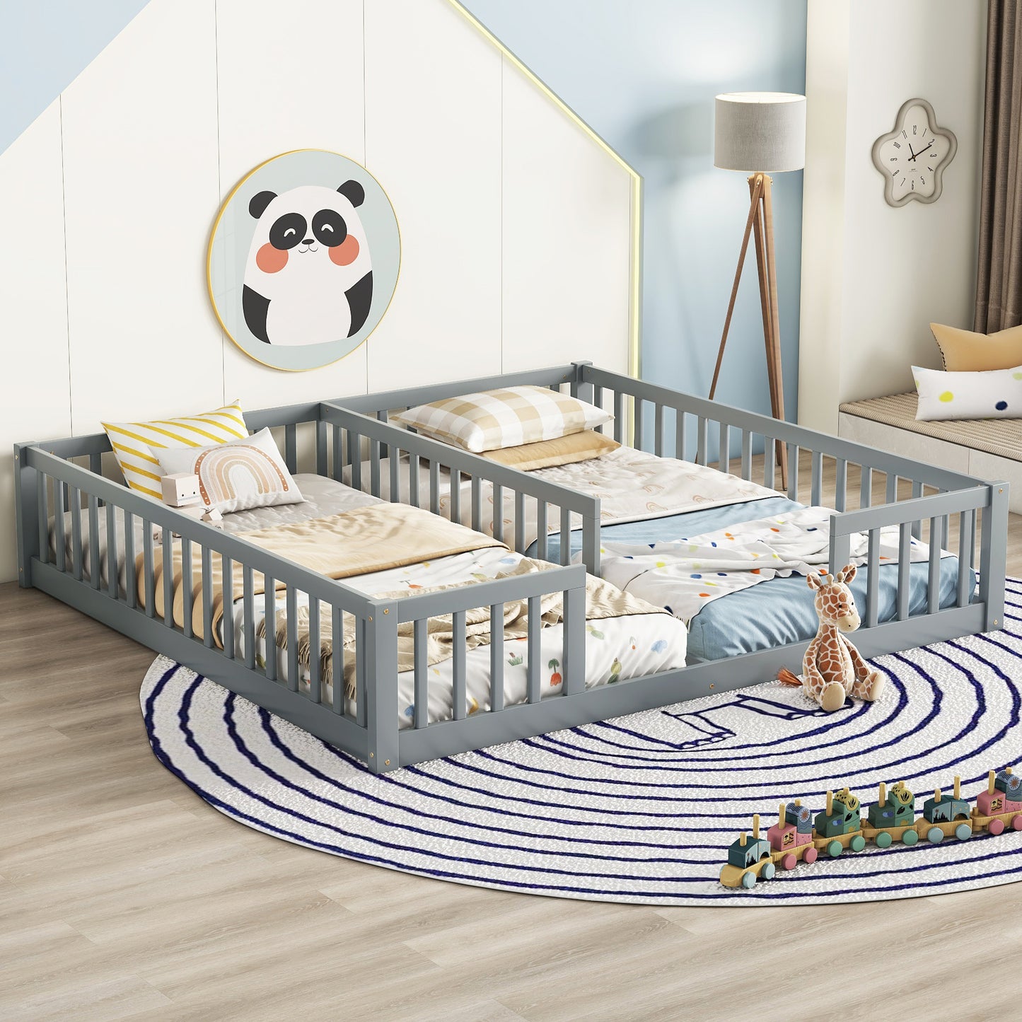 Grey wooden toddler bed with playful bedding and stuffed giraffe