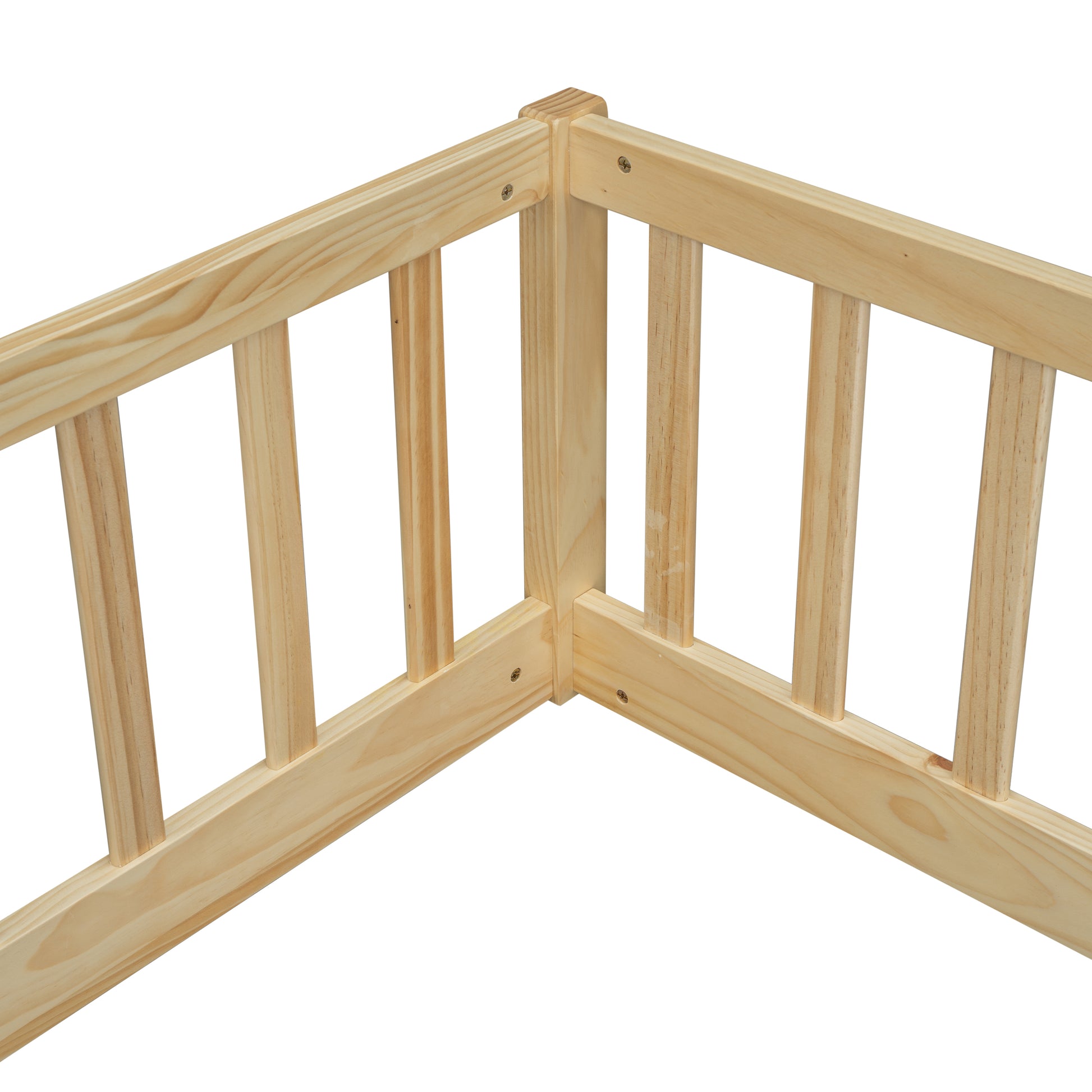 Natural pine wood corner join of a toddler bed safety rail