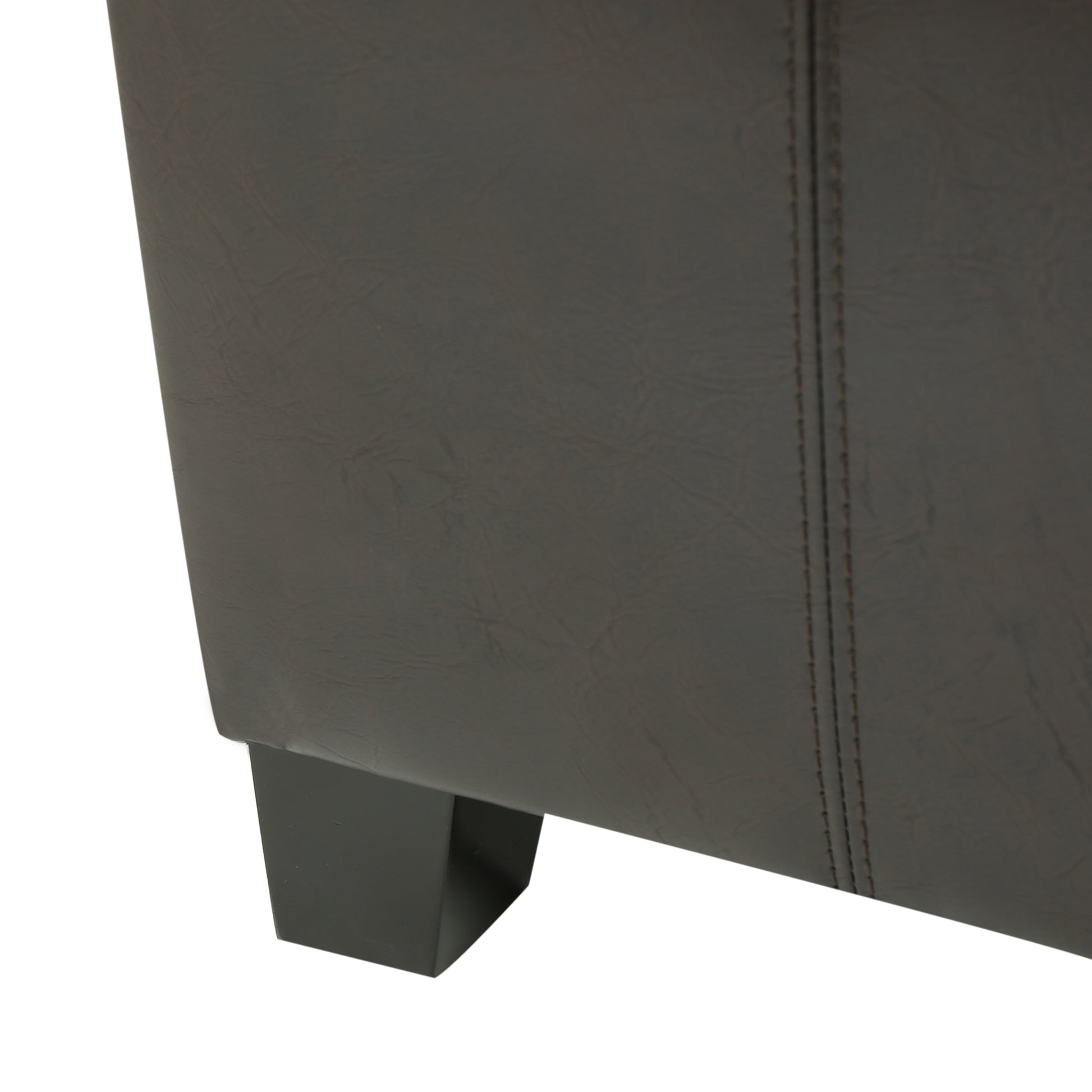 Dark brown faux leather armchair detail with modern black wooden legs