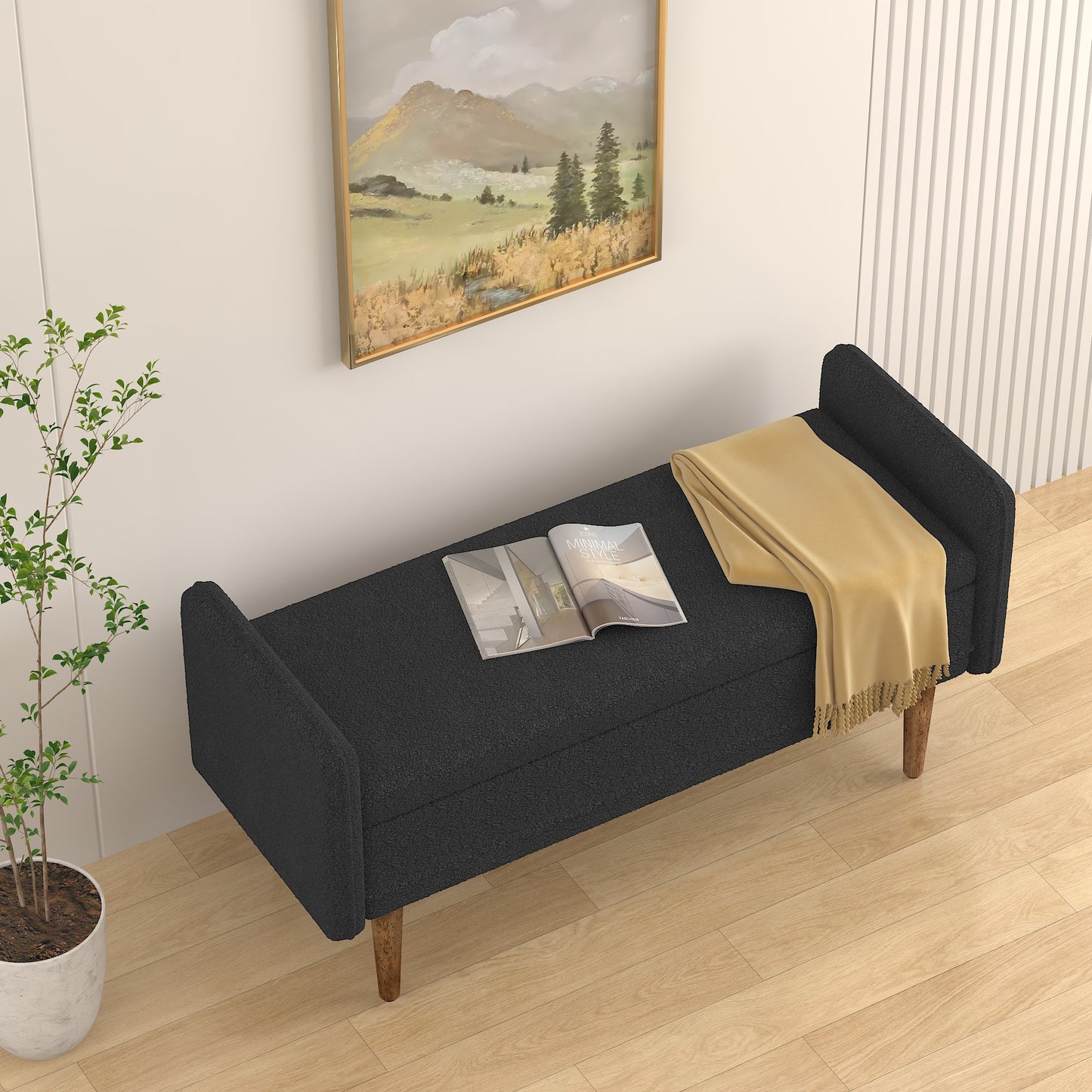 Dark grey fabric storage bench with wooden legs and a folded yellow throw blanket on top