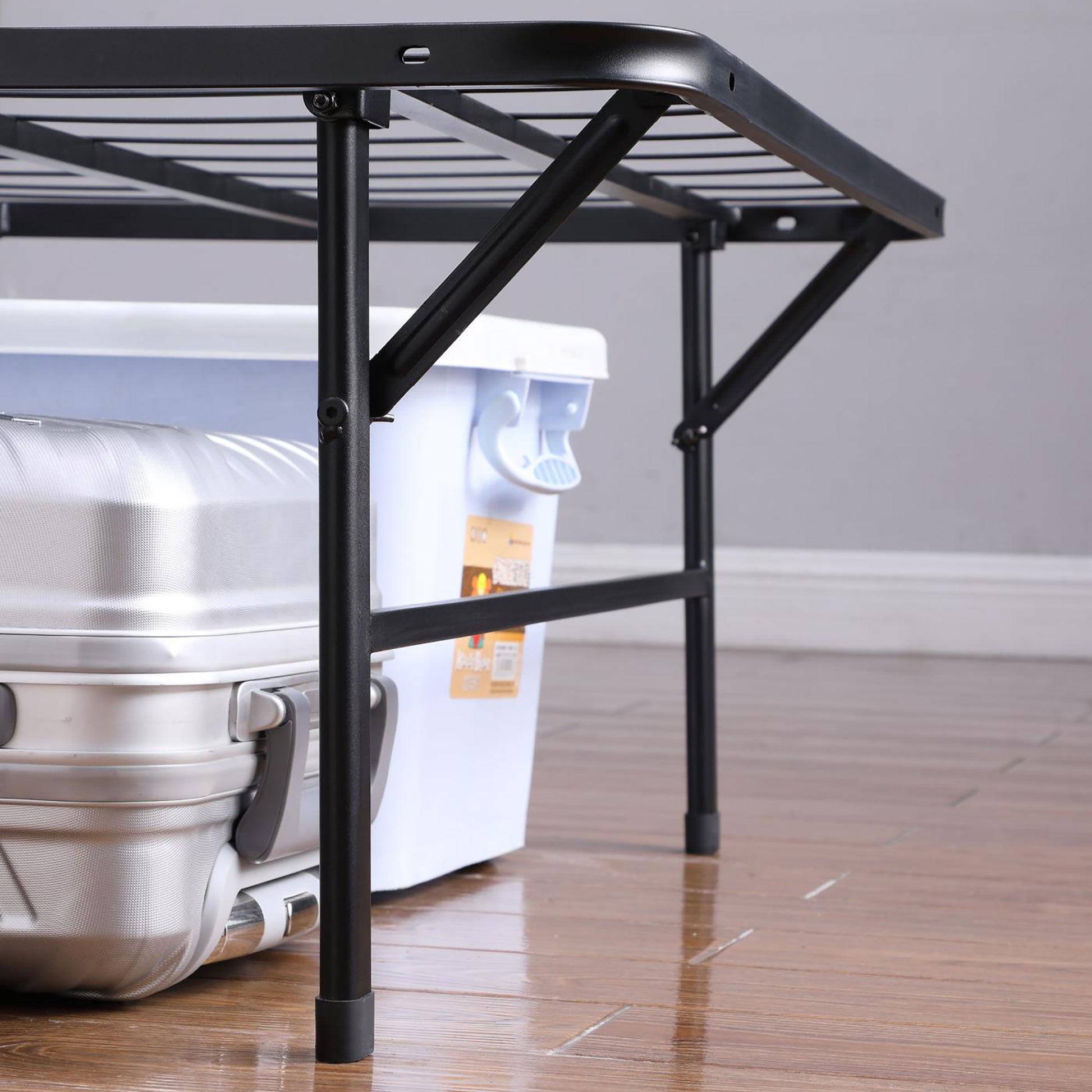 Black metal folding bed frame with storage underneath