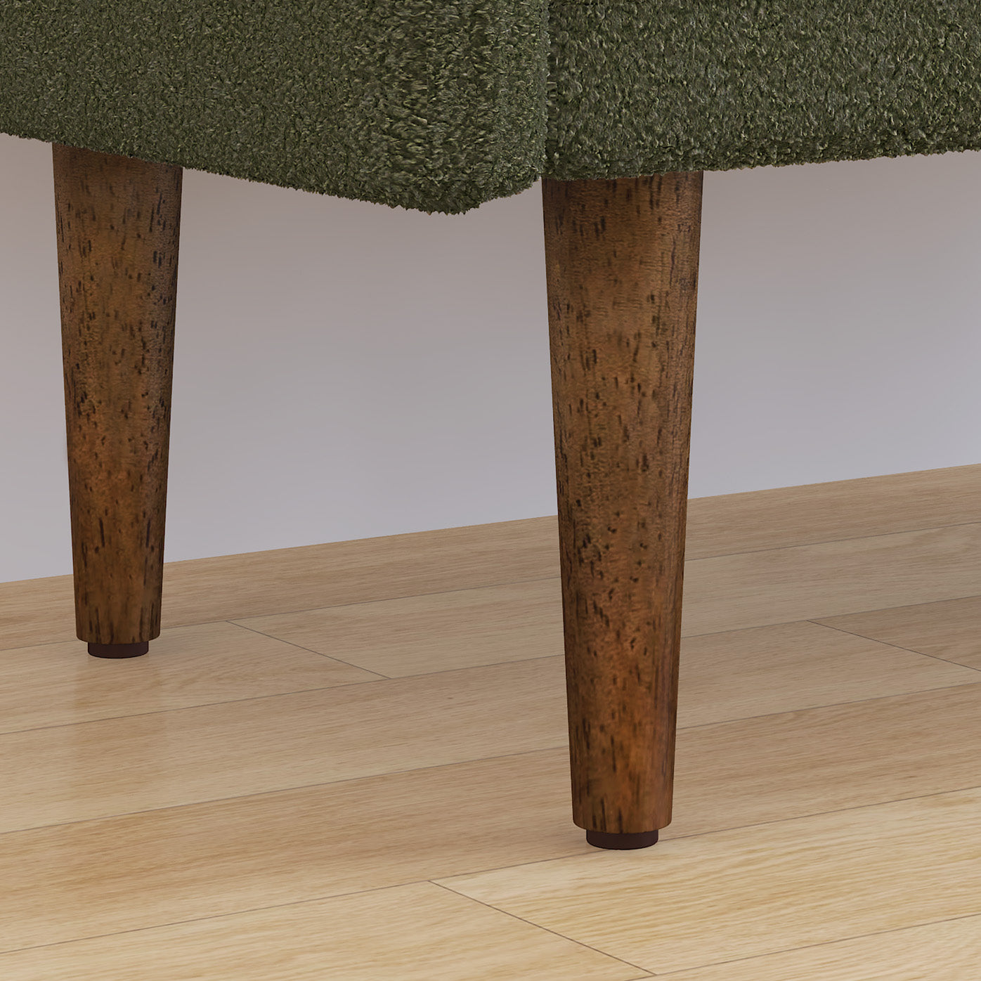 Green boucle fabric sofa detail with tapered wooden legs