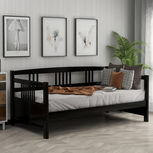Black wooden daybed with a white mattress and decorative pillows