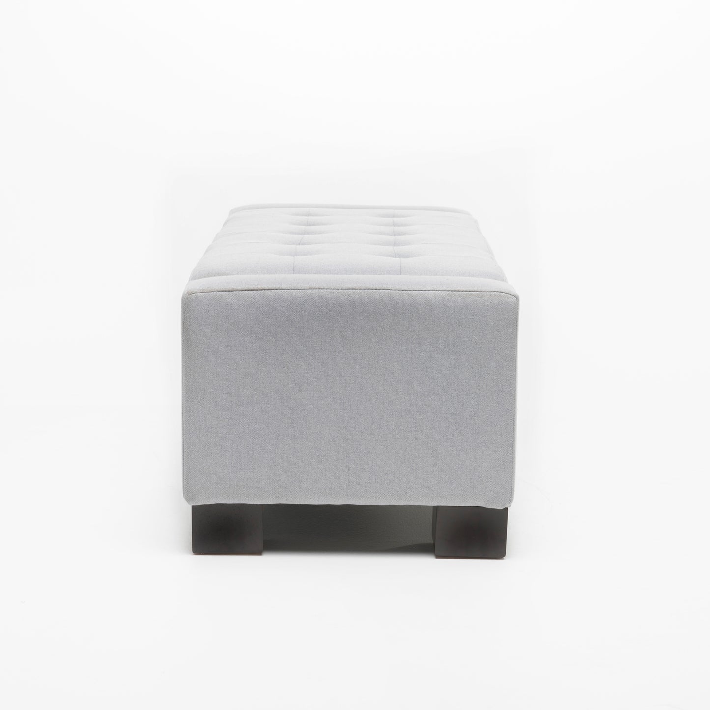 Gray fabric tufted ottoman with dark wood legs