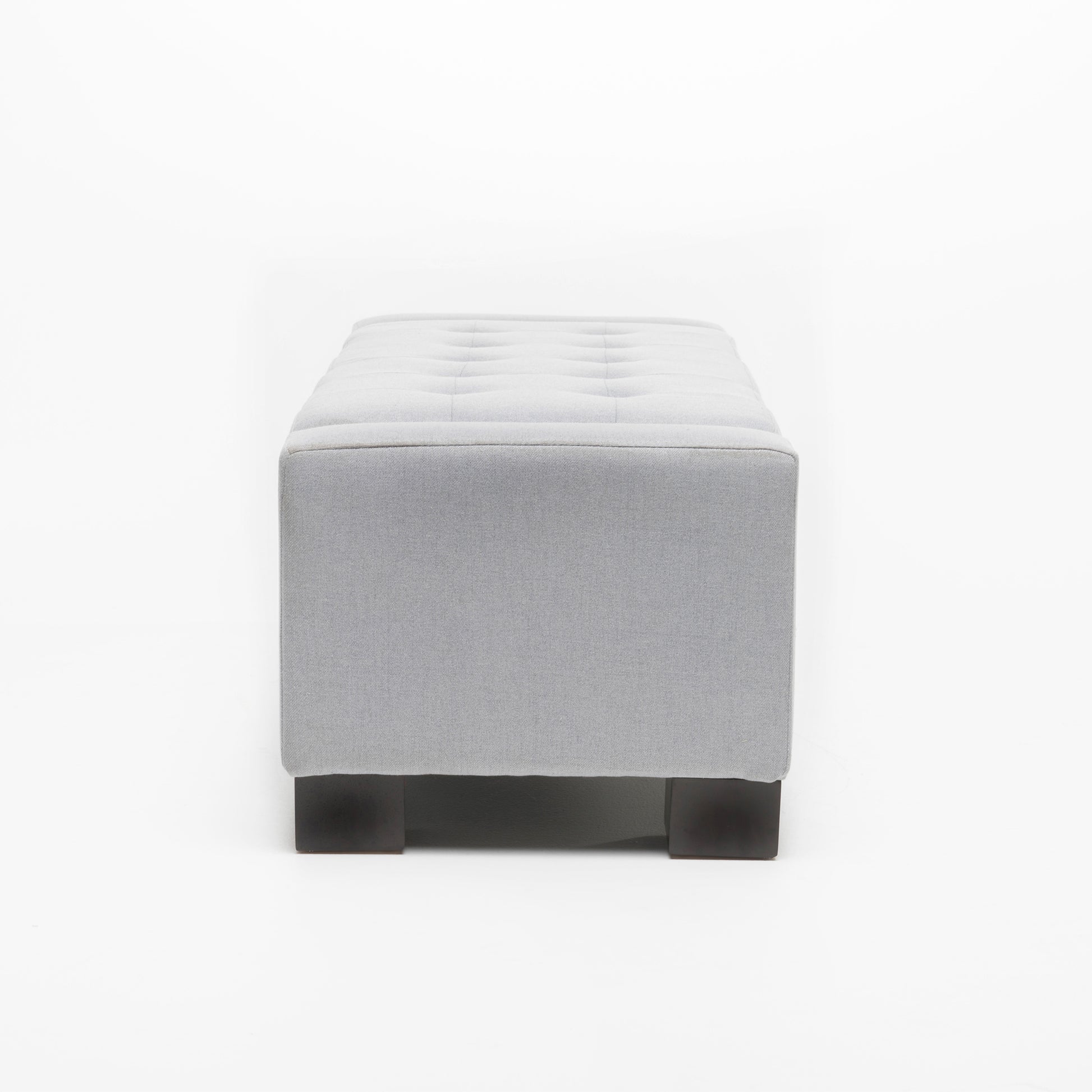 Gray fabric tufted ottoman with dark wood legs