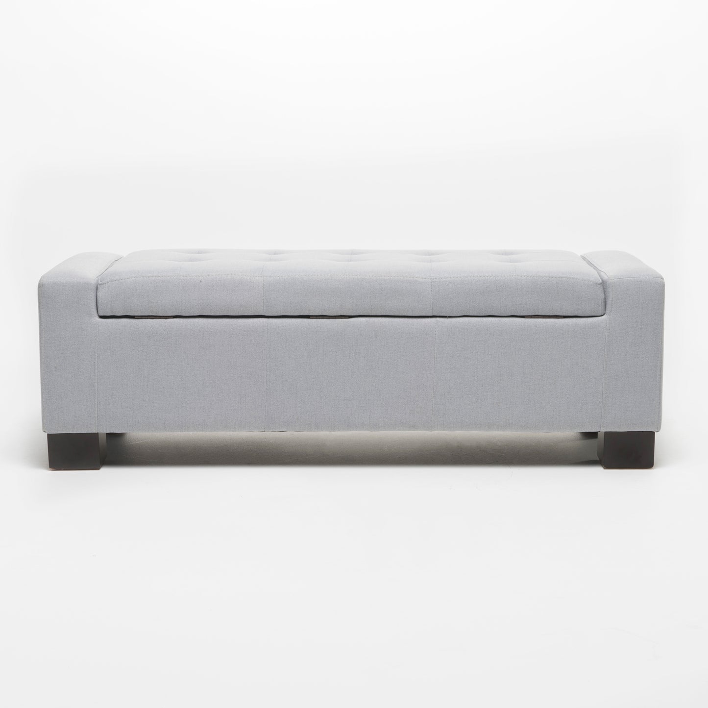 Light gray tufted storage ottoman with dark wood legs