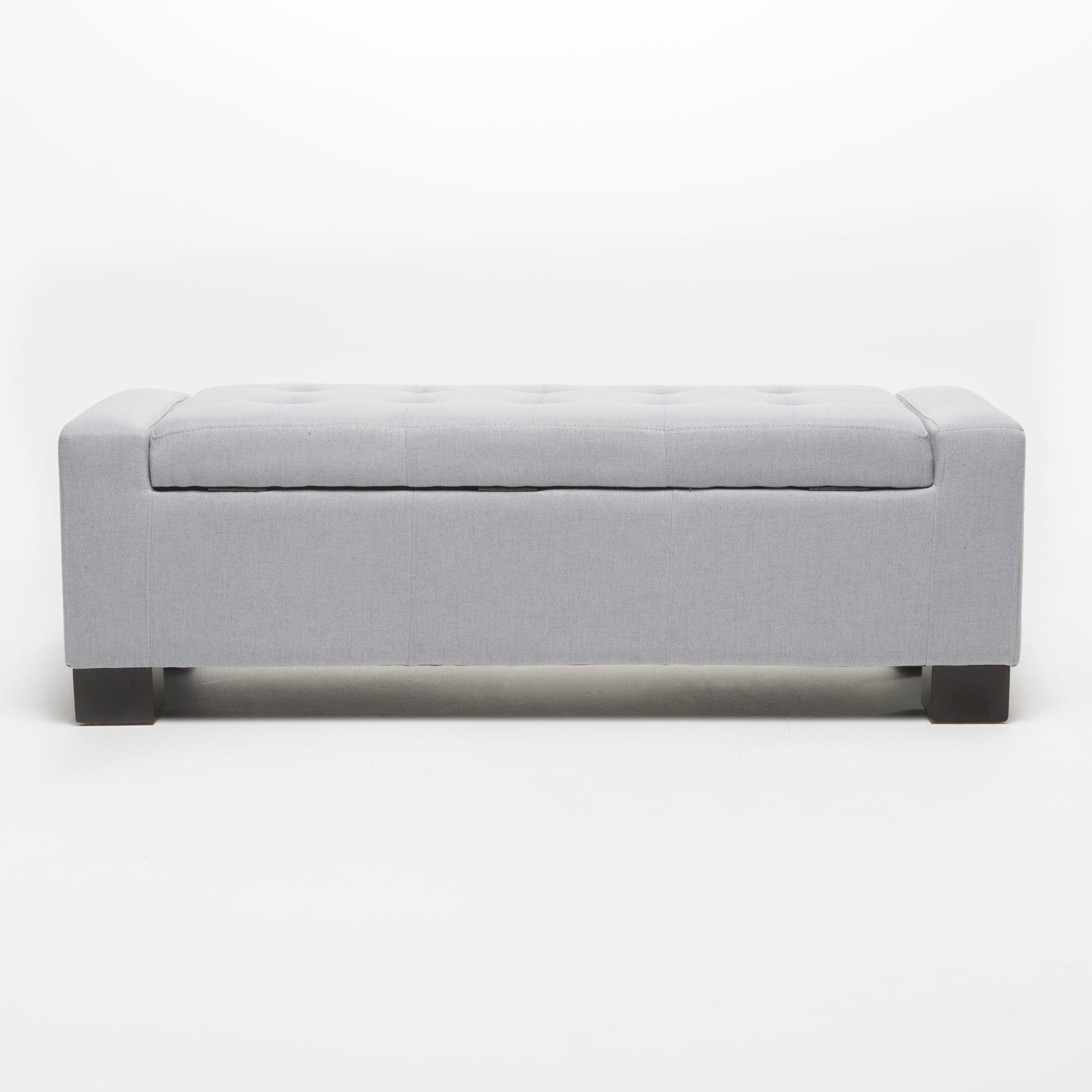 Light gray tufted storage ottoman with dark wood legs