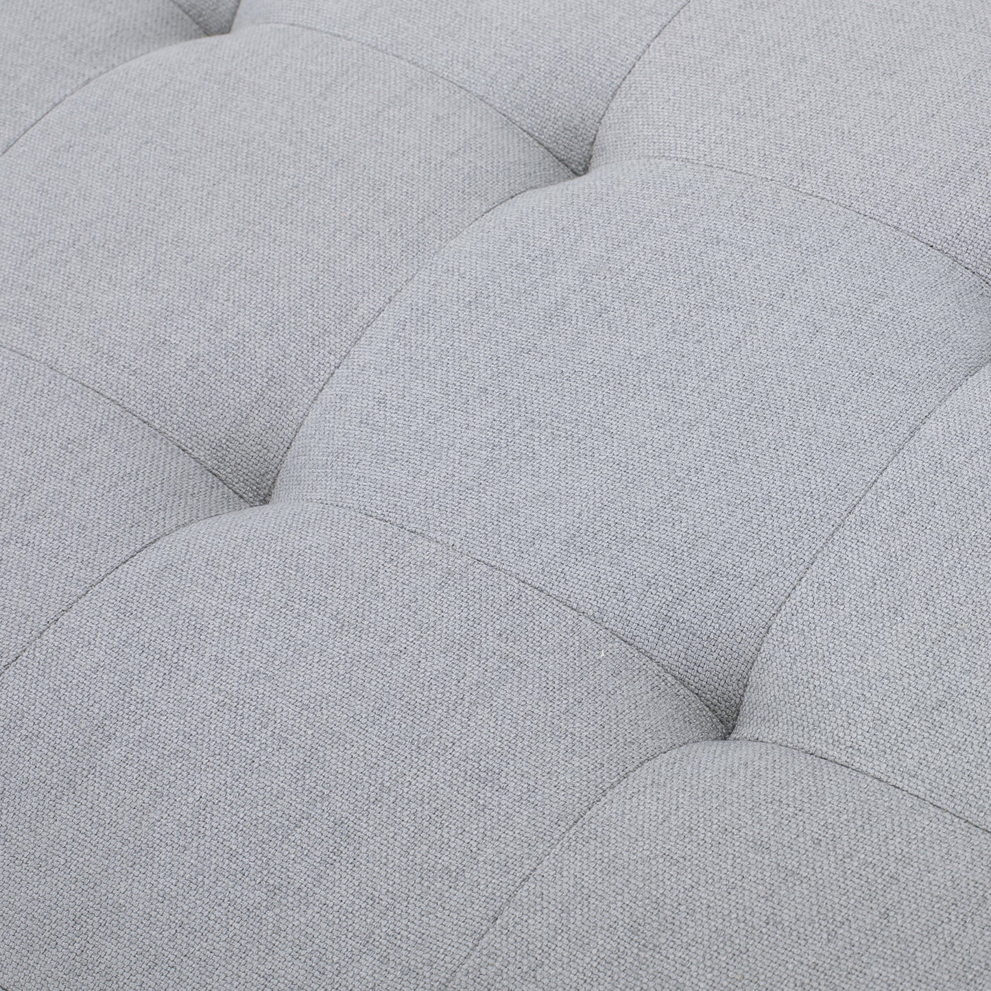 Closeup of light grey tufted fabric texture