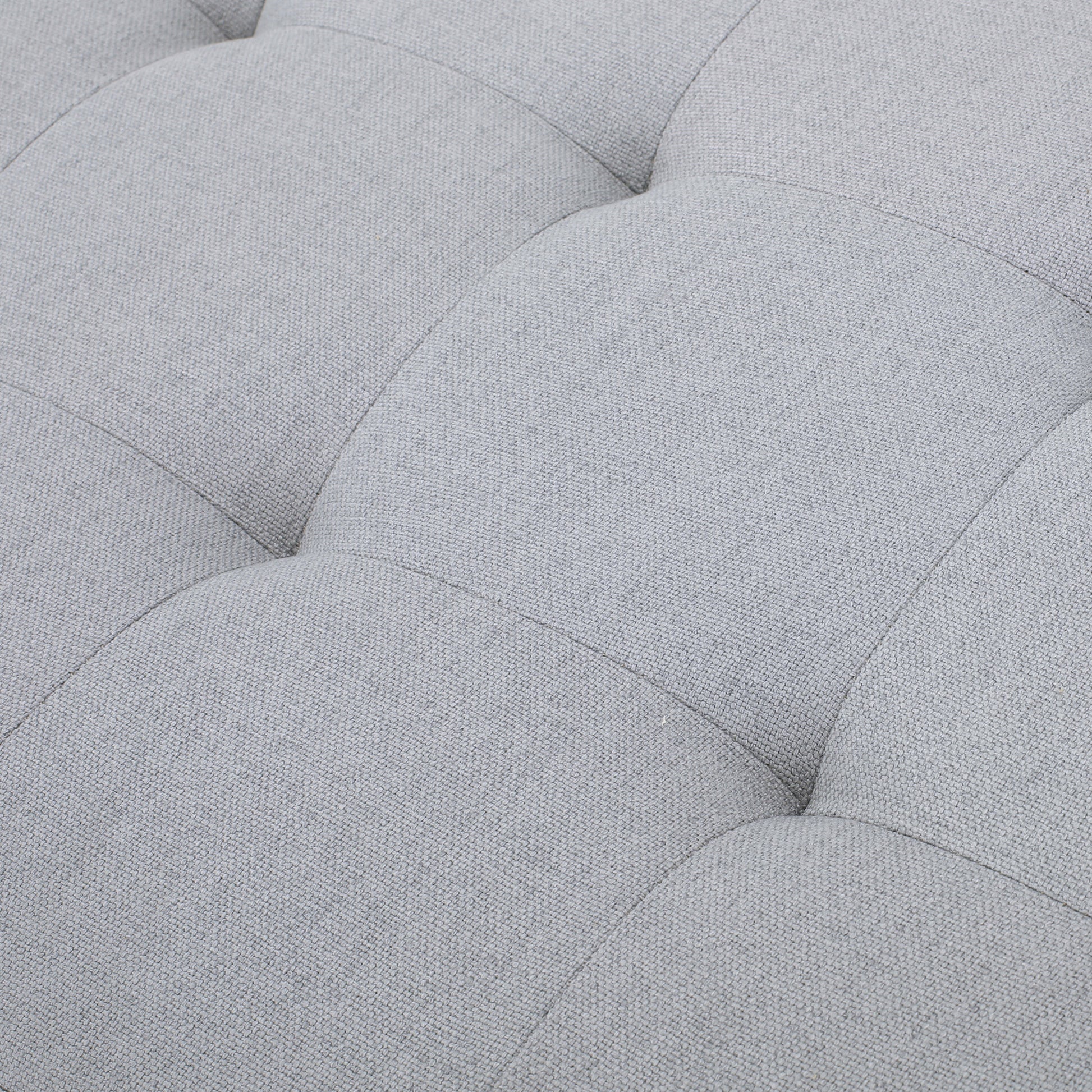 Closeup of light grey tufted fabric texture