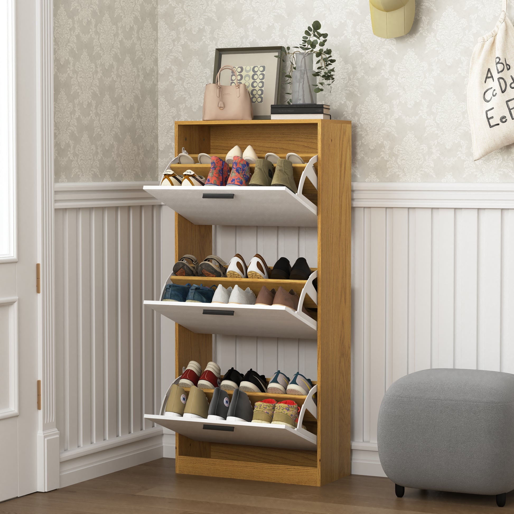 Compact wooden shoe cabinet with three flipout drawers storing various shoes