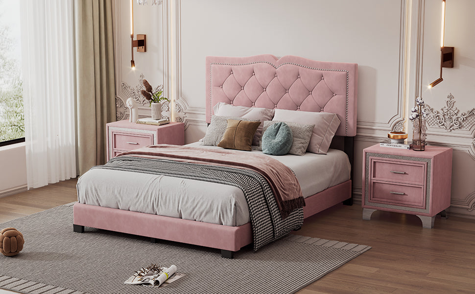 Pink velvet tufted bed with ornate headboard