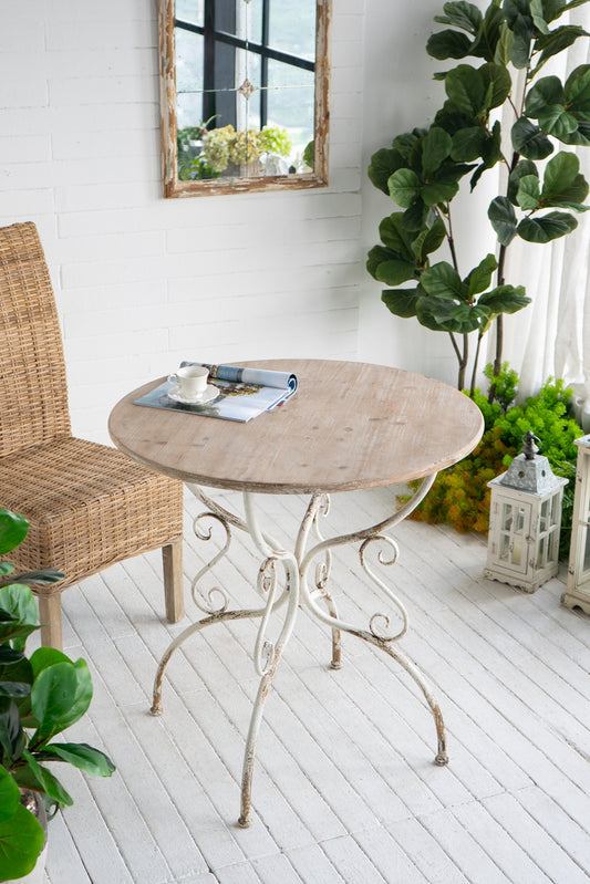 Round wood bistro table with white ornate metal base