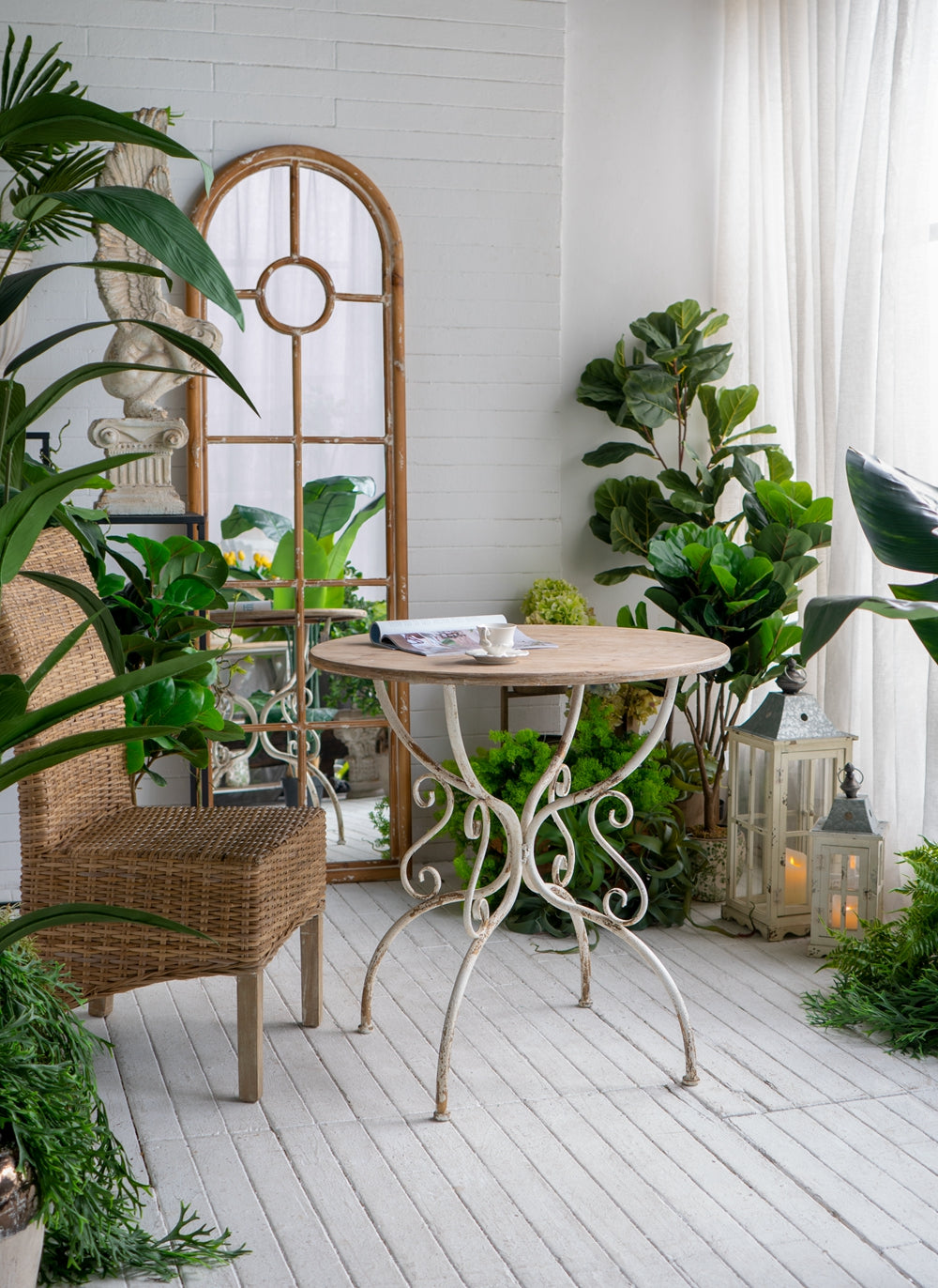 French country style bistro table with distressed white metal base and round wood top